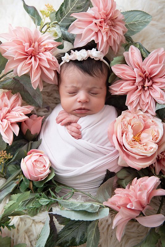newborn photo baby surrounded by flowers