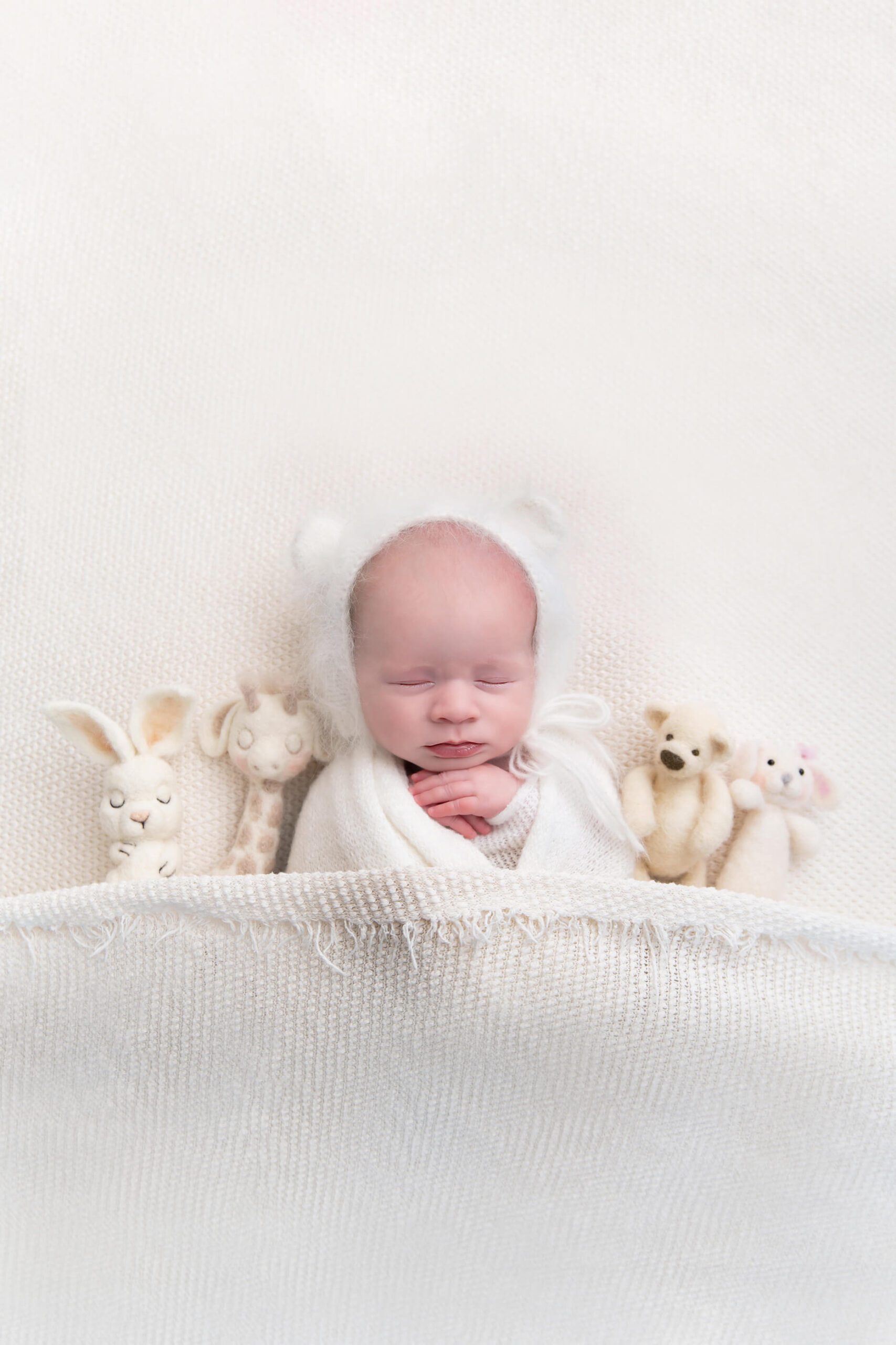 newborn baby with tiny props