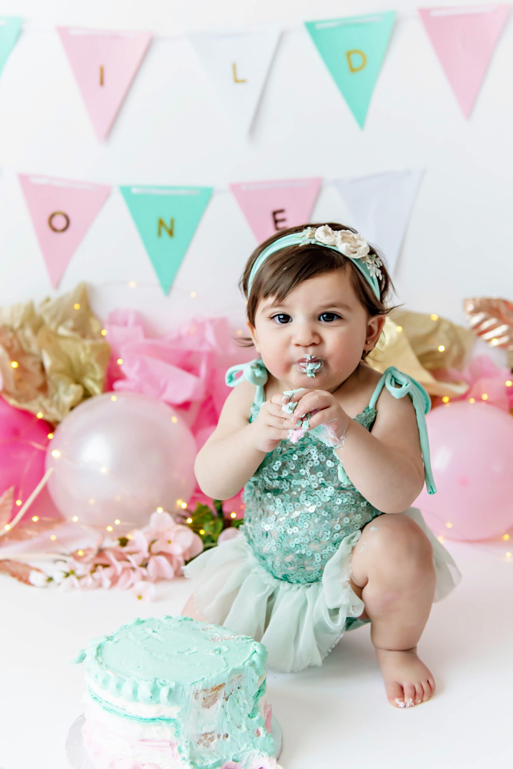up close photo of baby at her cake smash session in studio Burlington Ontario