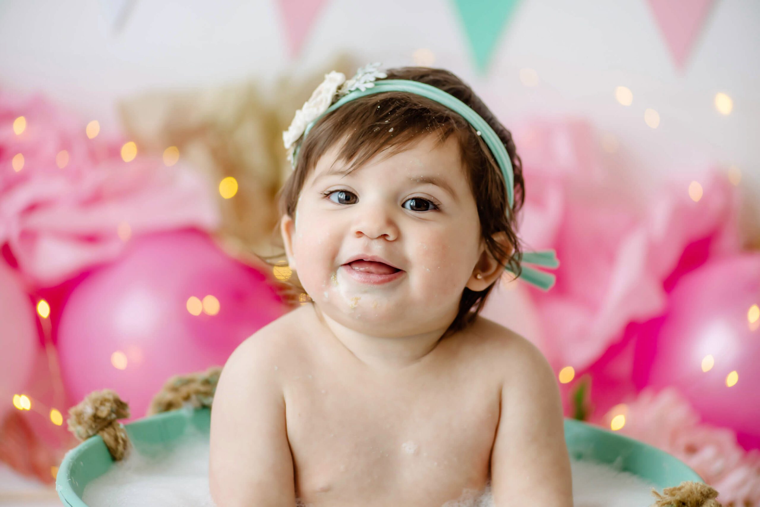 up close photo of baby at her cake smash session in studio Burlington Ontario