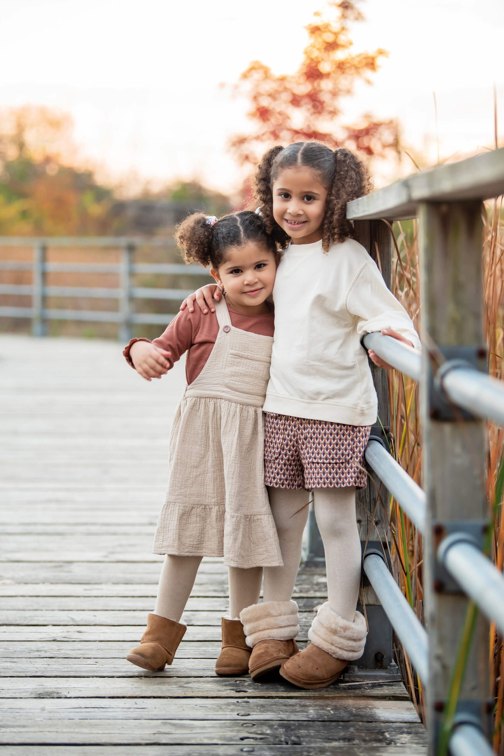 sisters on the boardwalk at their fall family photography session