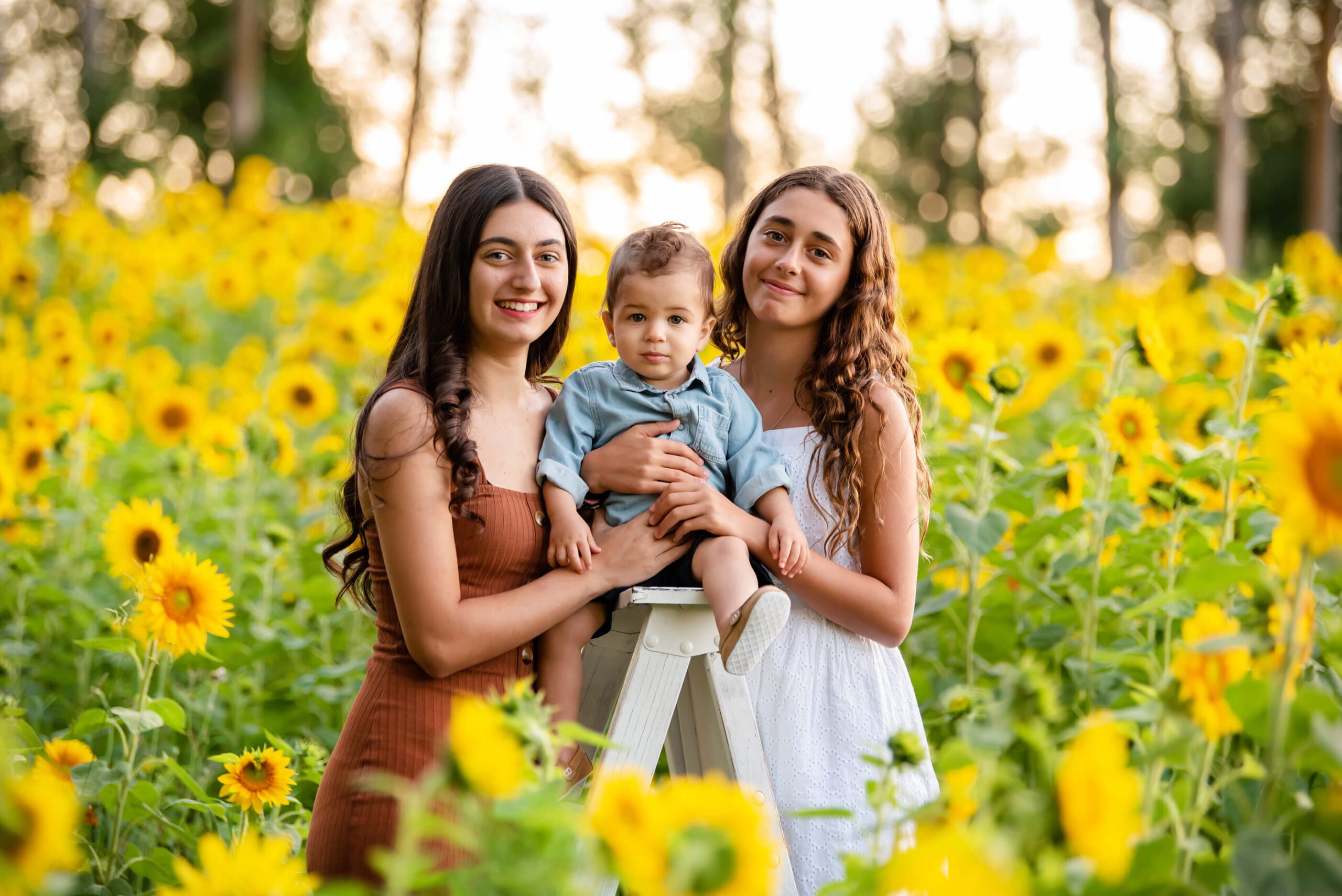 sisters with brother at the sunflower farm