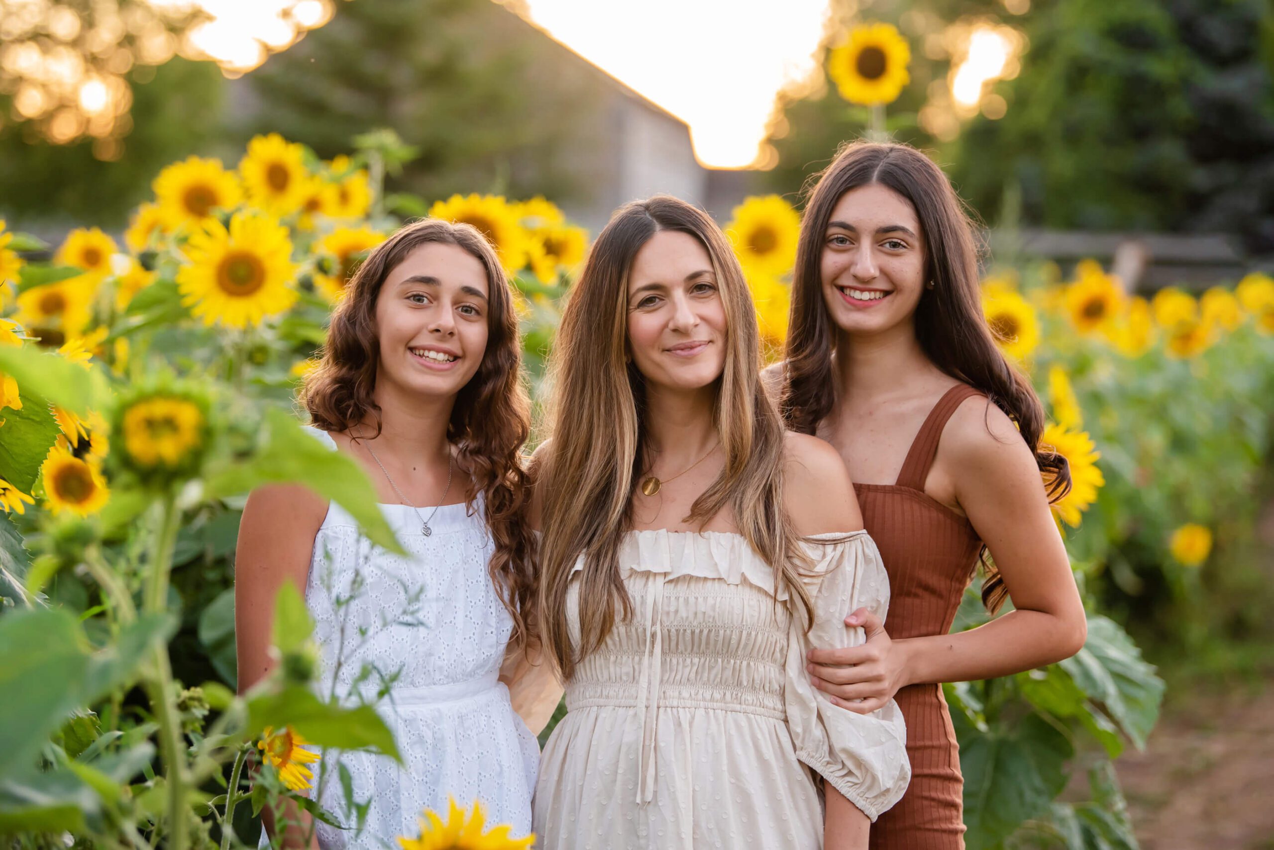 mom with daughters at the sunflower farm