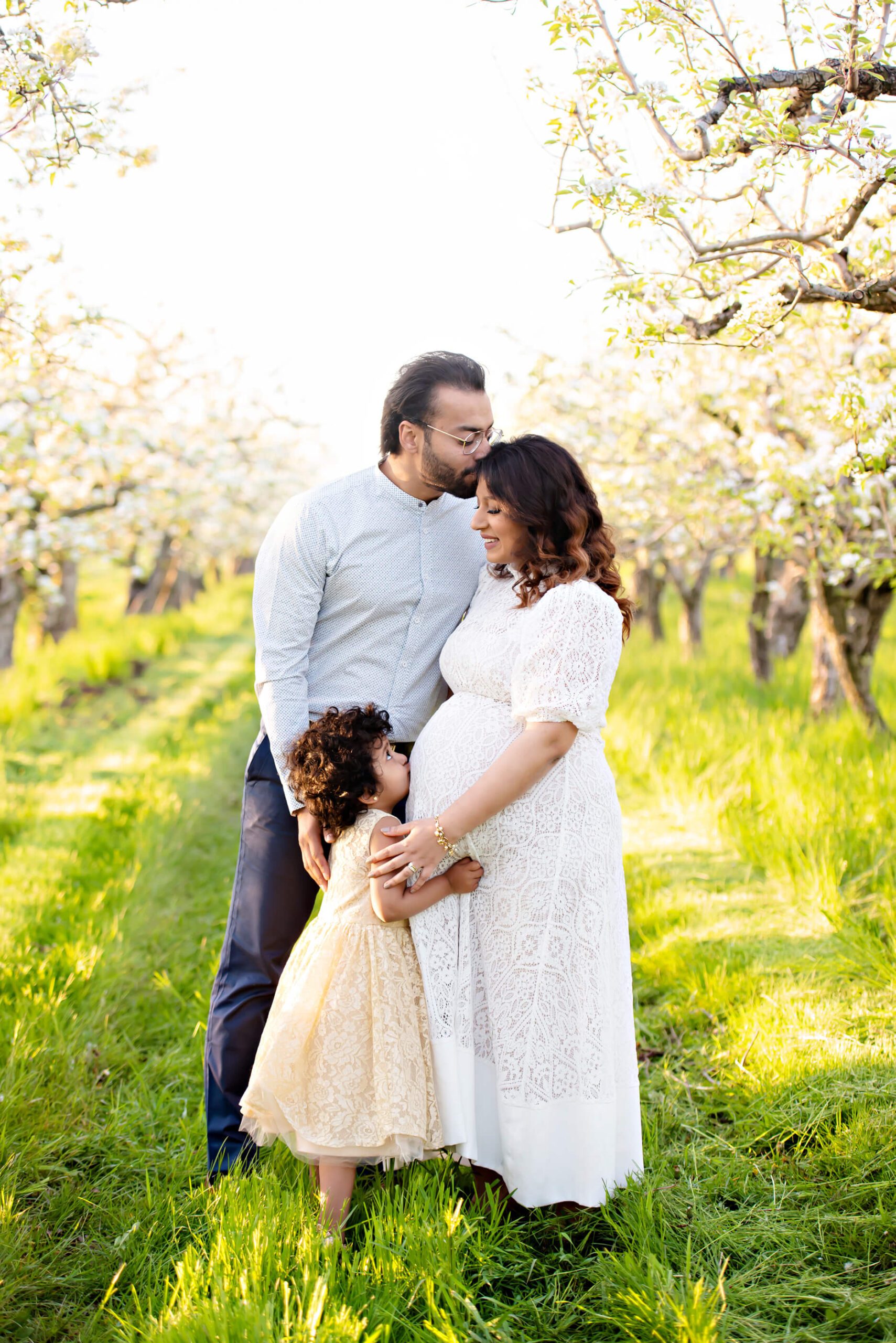 family maternity photo at the cherry blossom farm
