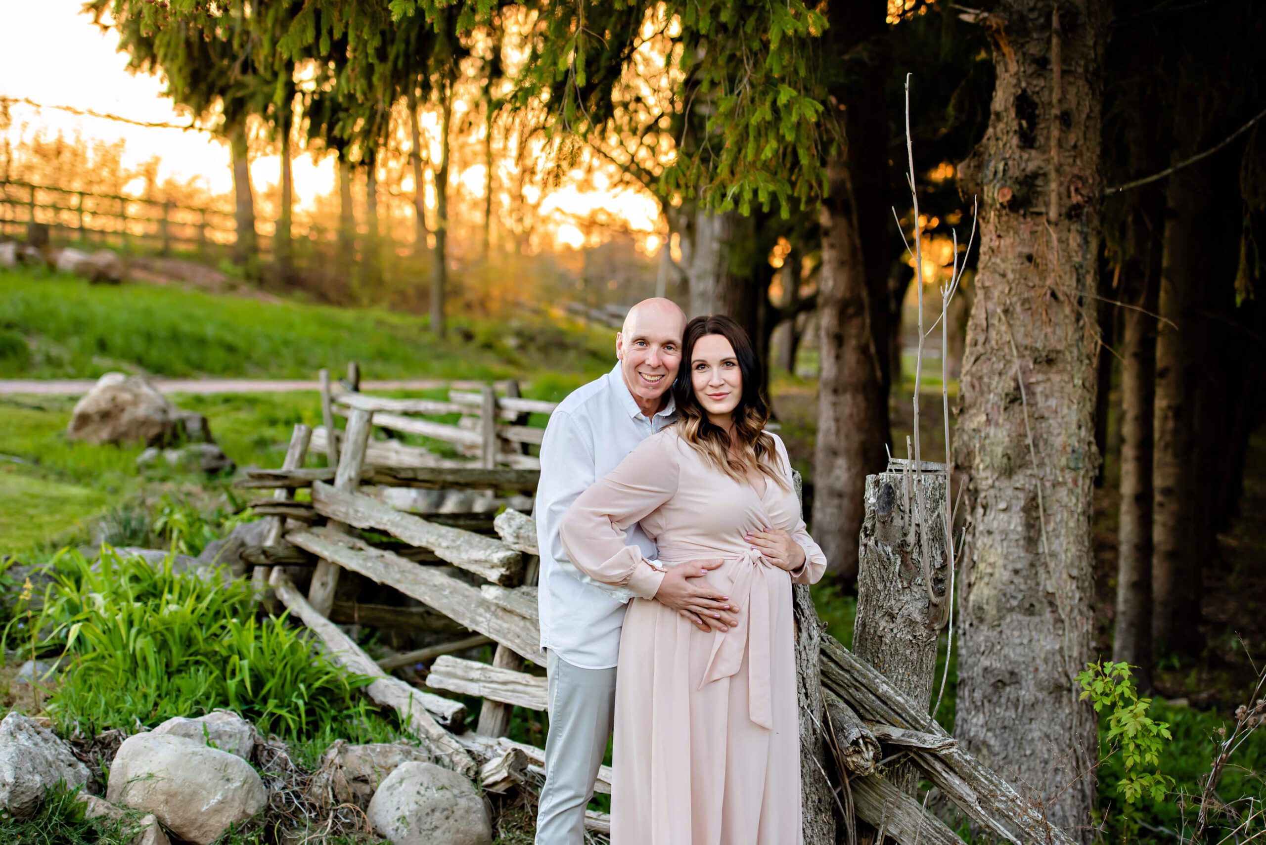 husband and wife at a farm at sunset for their Toronto maternity session