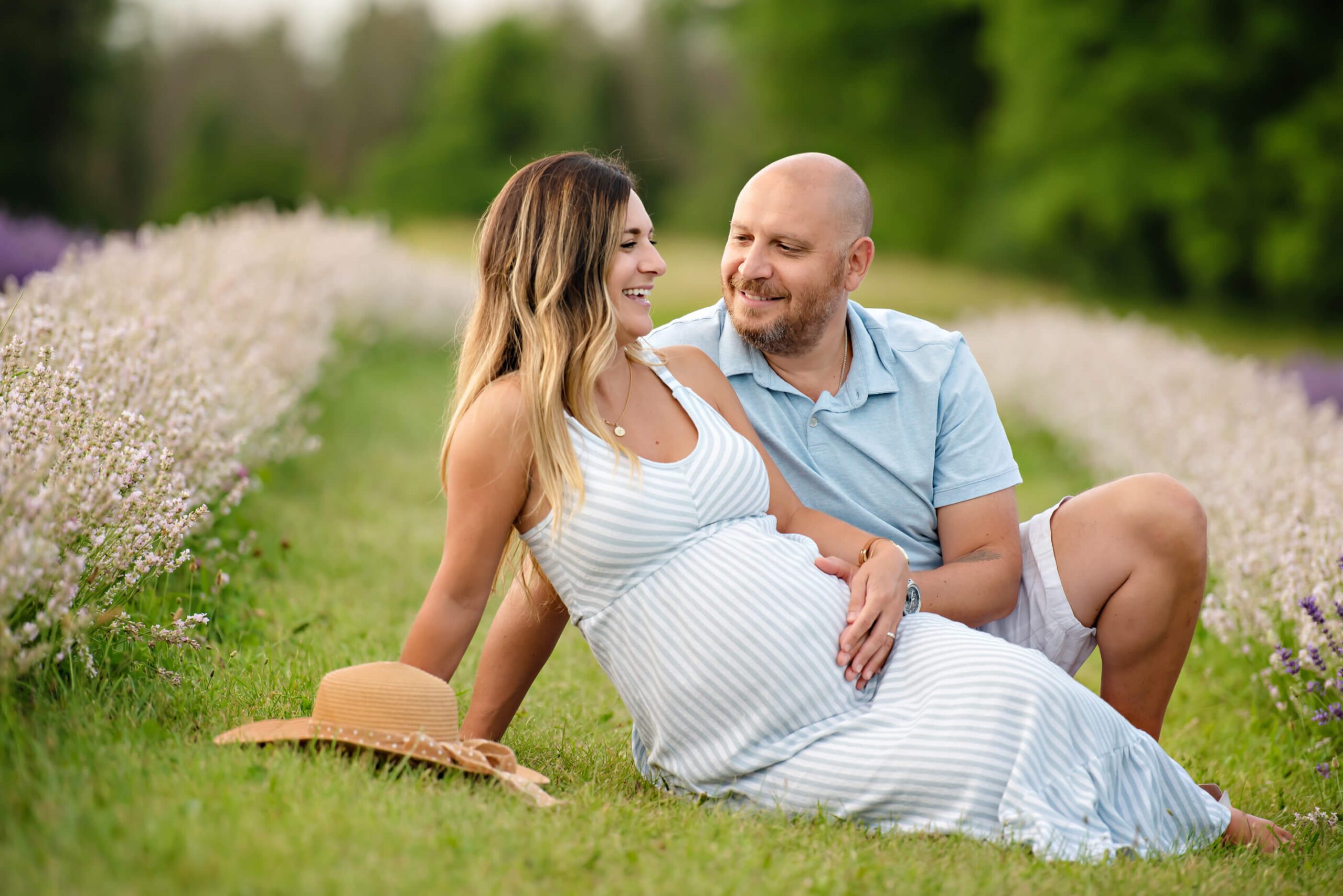husband and wife in the lavender field for their maternity photography session