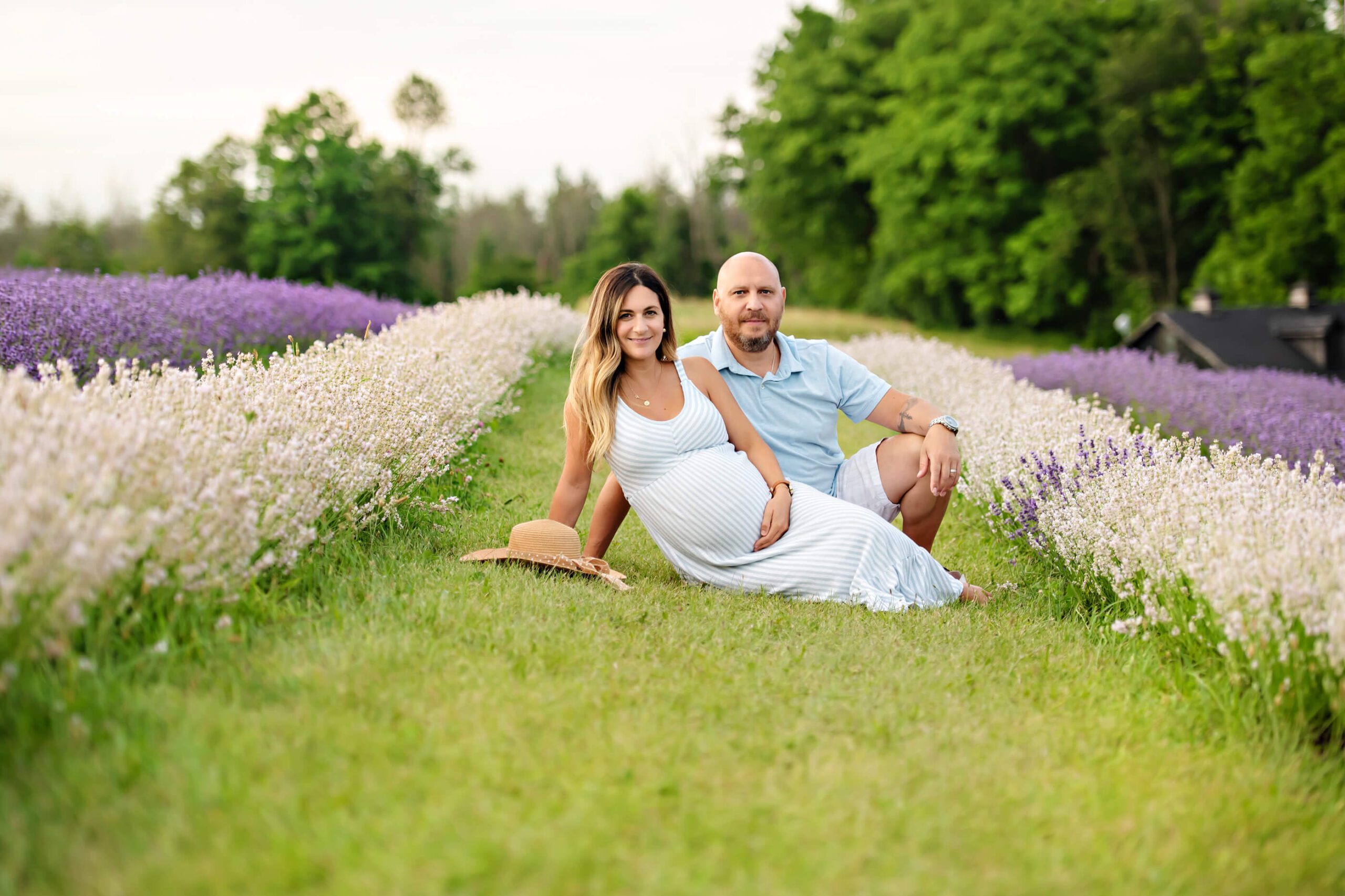 couple in the lavender field for their maternity photos