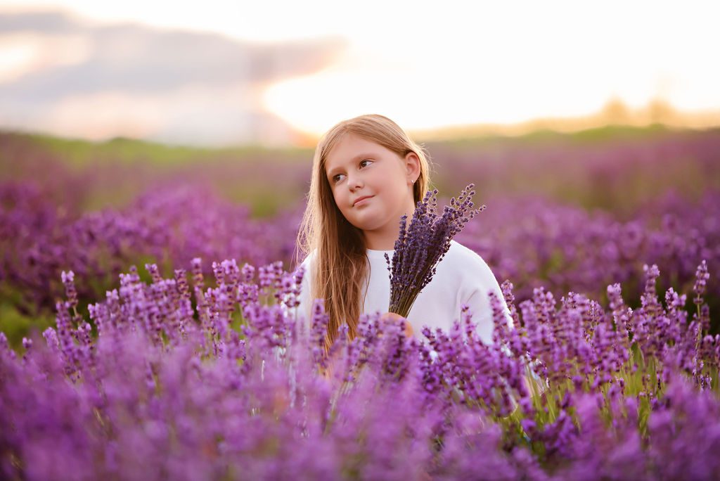 Young girl holding a bundle of lavender while standing in a lavender field Gynecologists in Burlington Ontario
