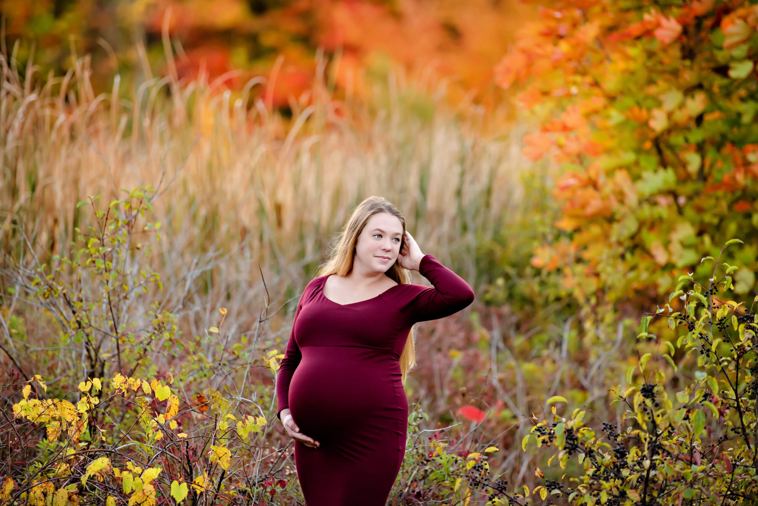 fall maternity session mom in burgundy dress 