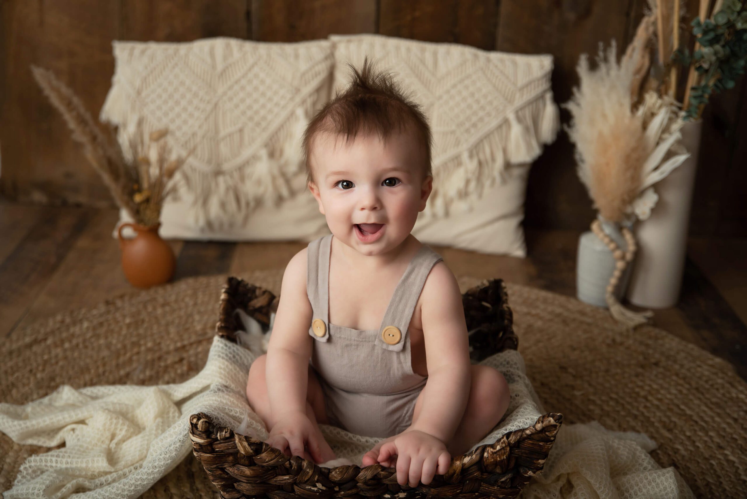 Baby boy sitting in a basket boho style children's photographer