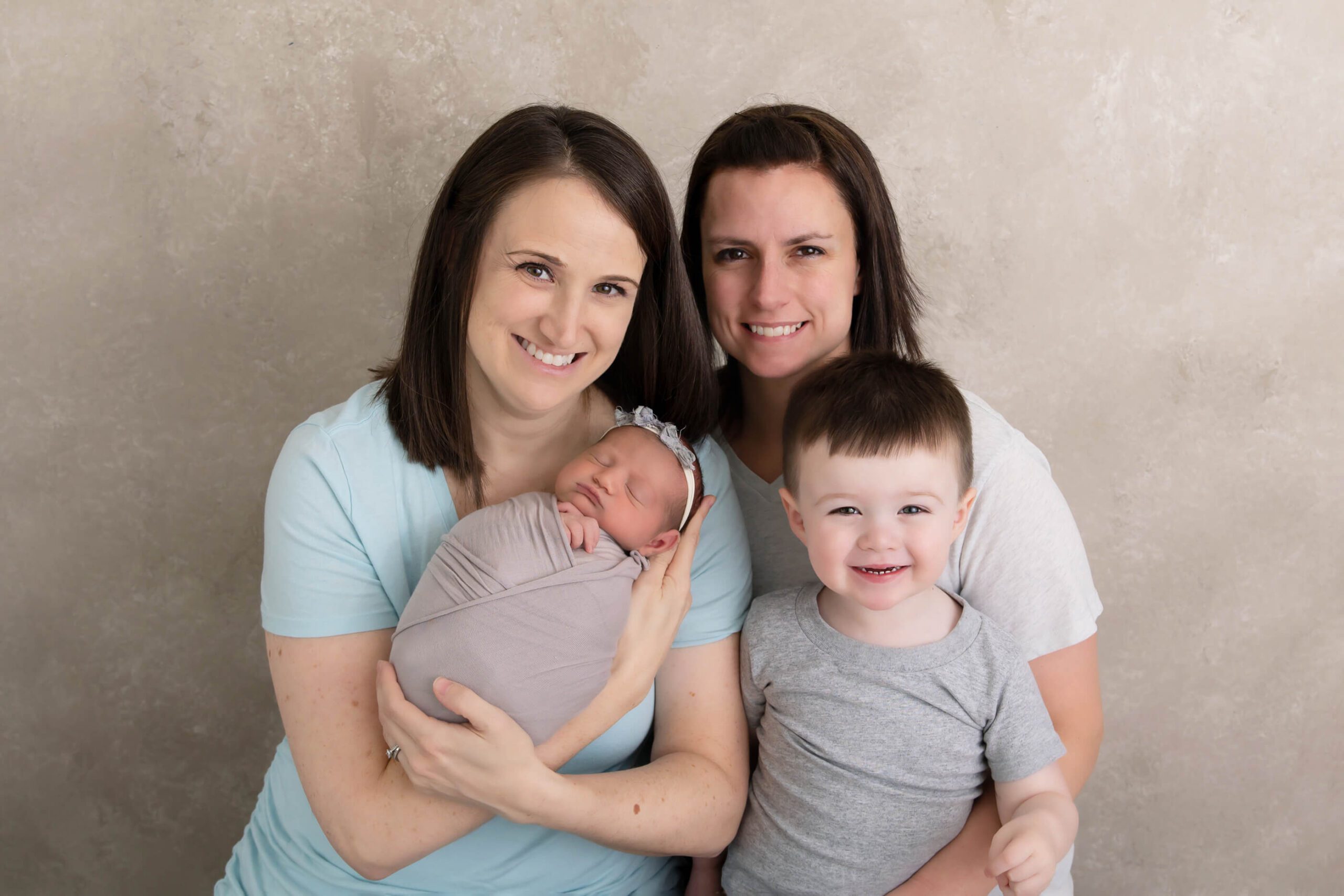 Family of four with same-sex couple for the newborn photography session, One Fertility Burlington 