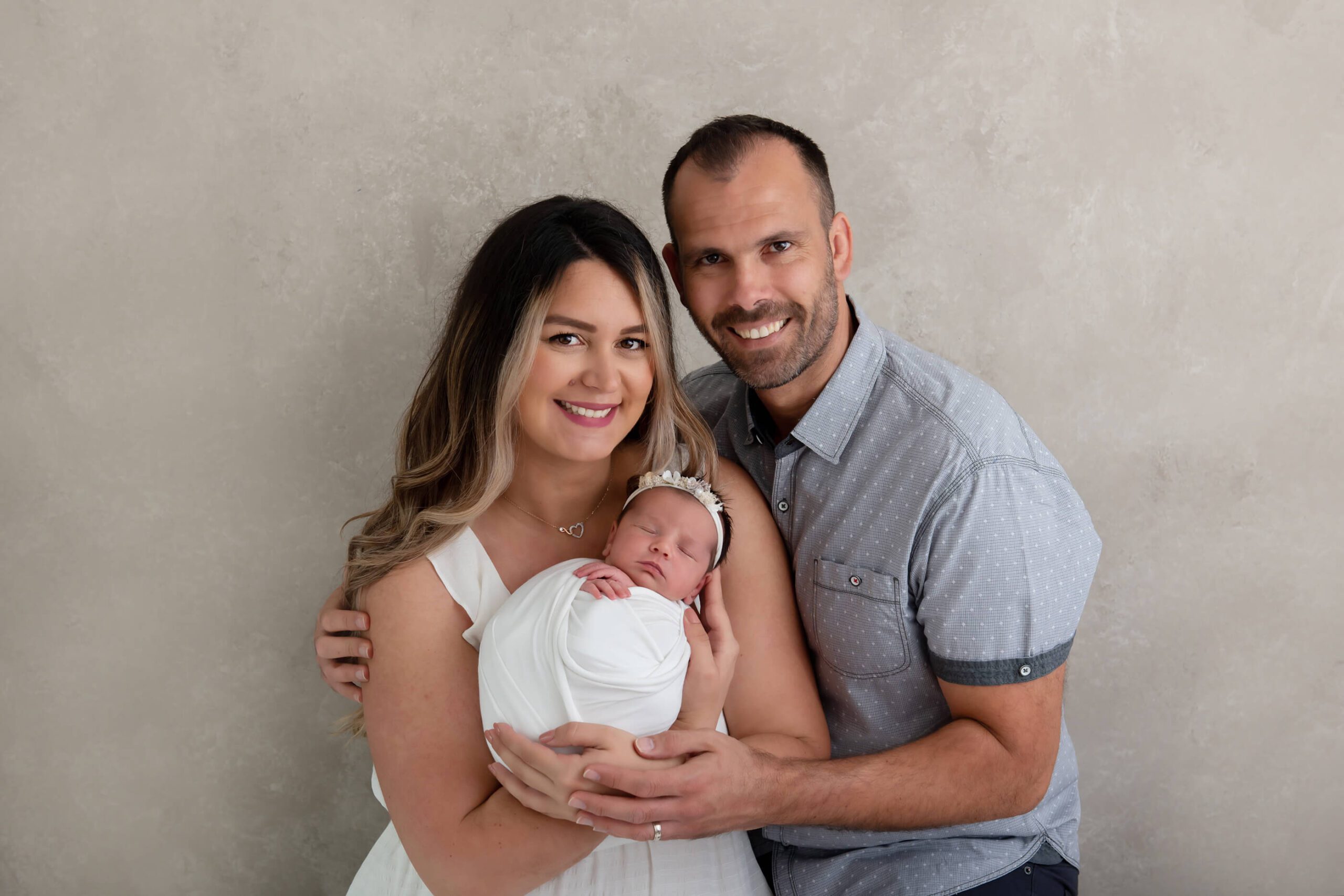 mom and dad holding newborn girl for Burlington newborn photographer