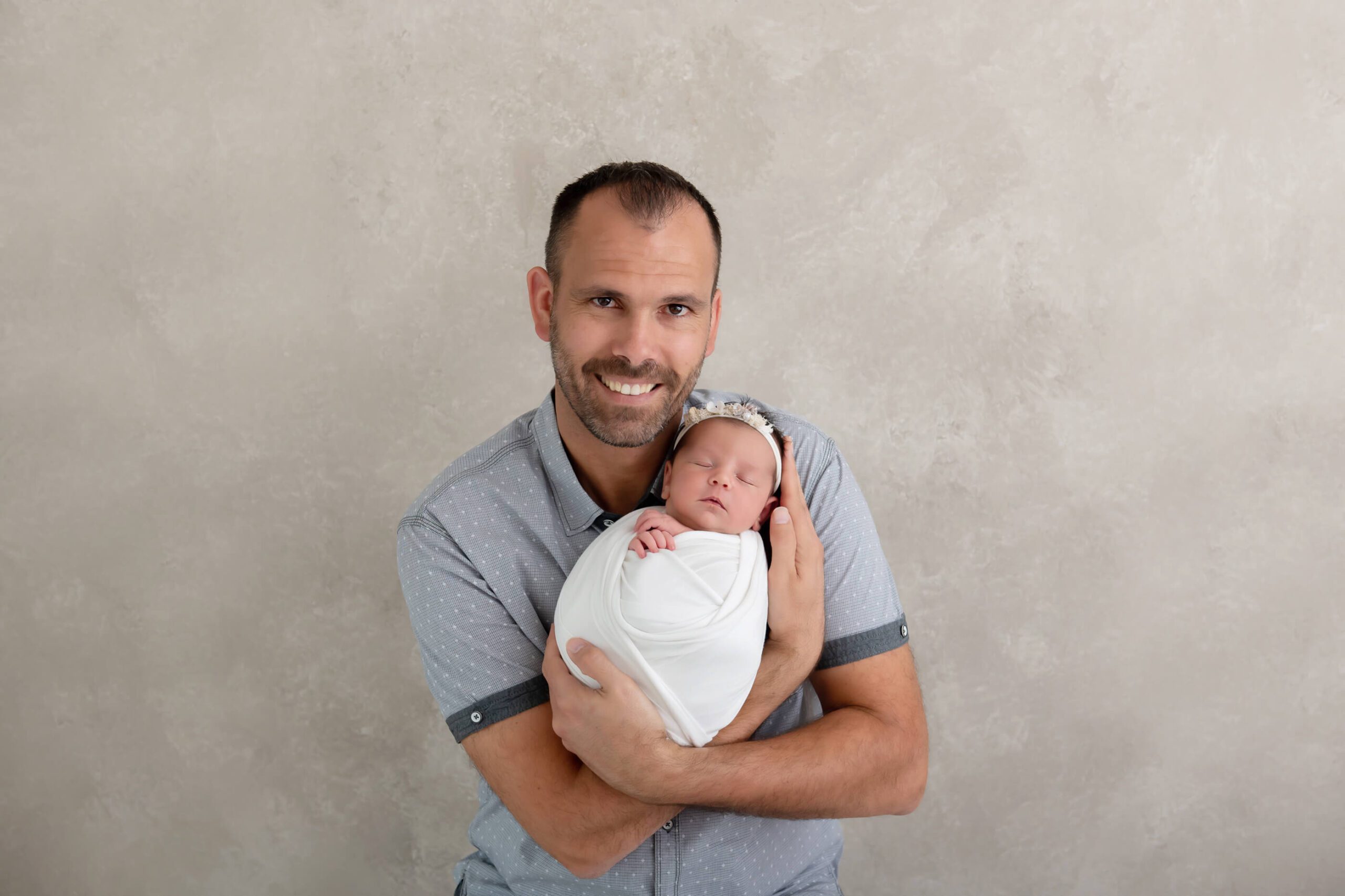 dad holding newborn girl for Burlington newborn photography