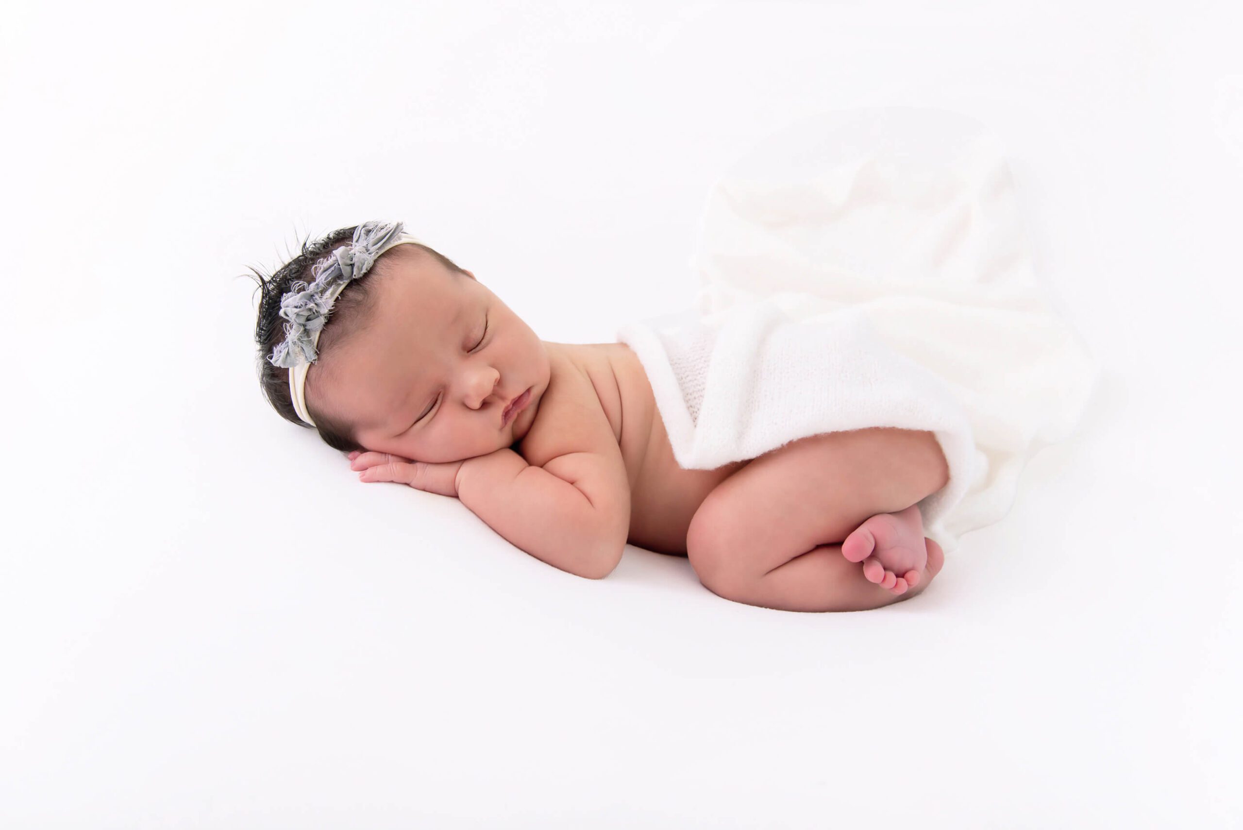 newborn baby laying down on white background Burlington newborn photographer