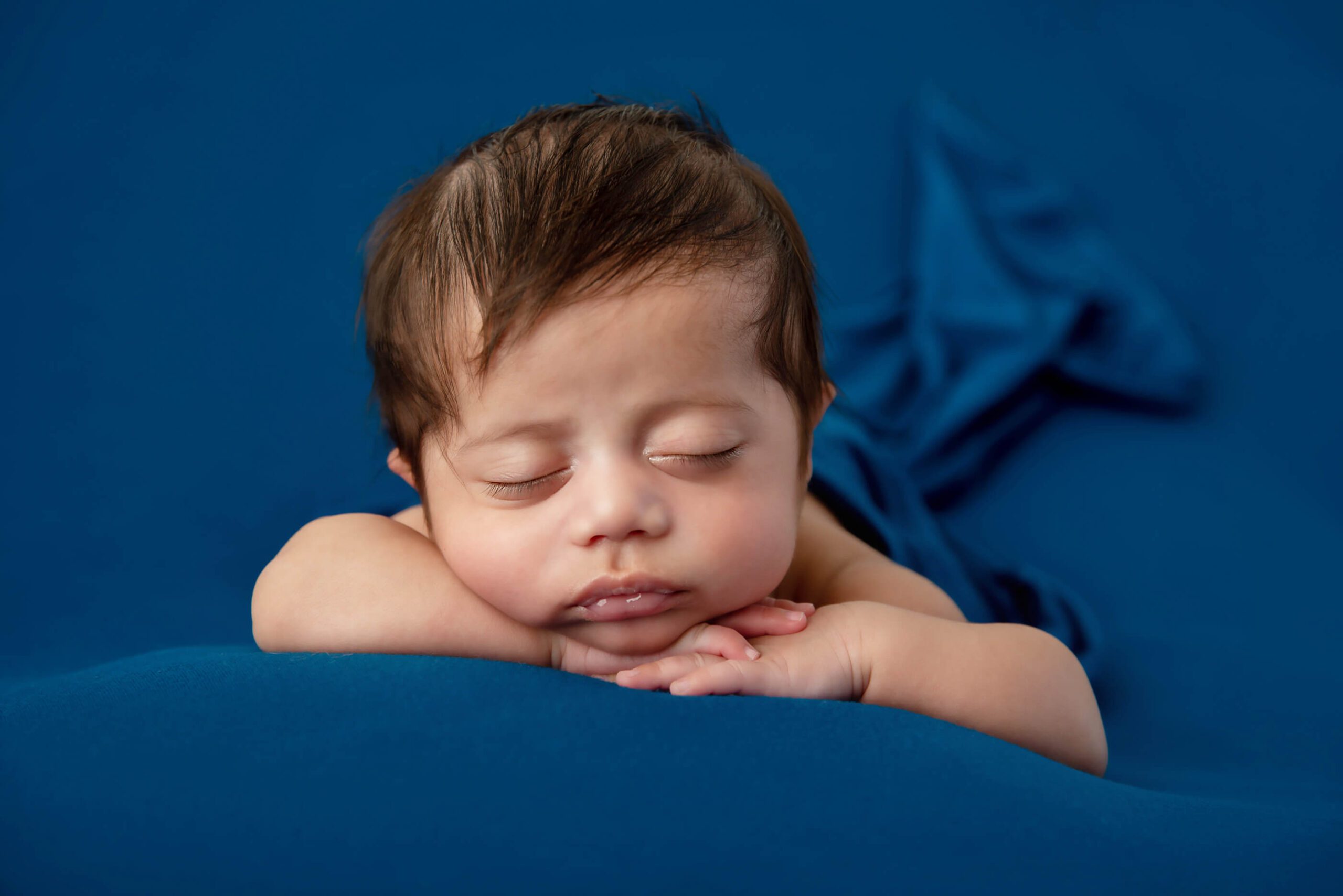 newborn baby boy on a blue background Burlington newborn photos
