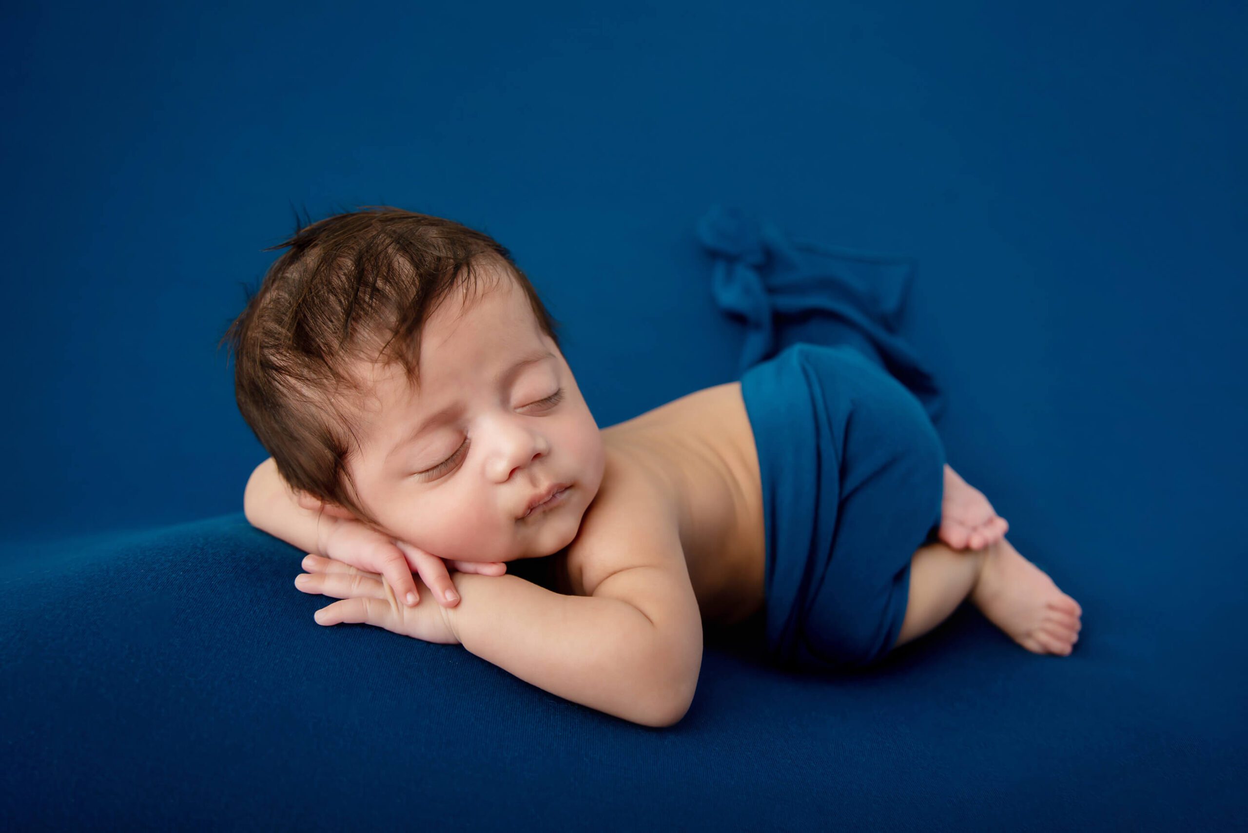 newborn baby boy on a blue background Burlington newborn photography