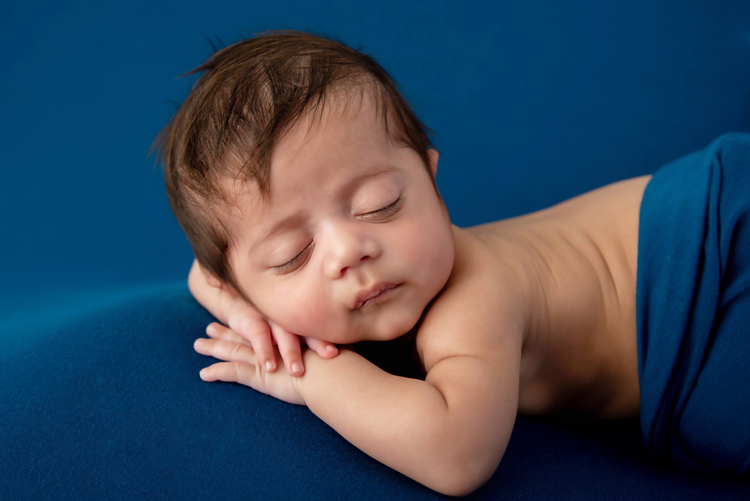 newborn baby boy on a blue background Burlington newborn photography