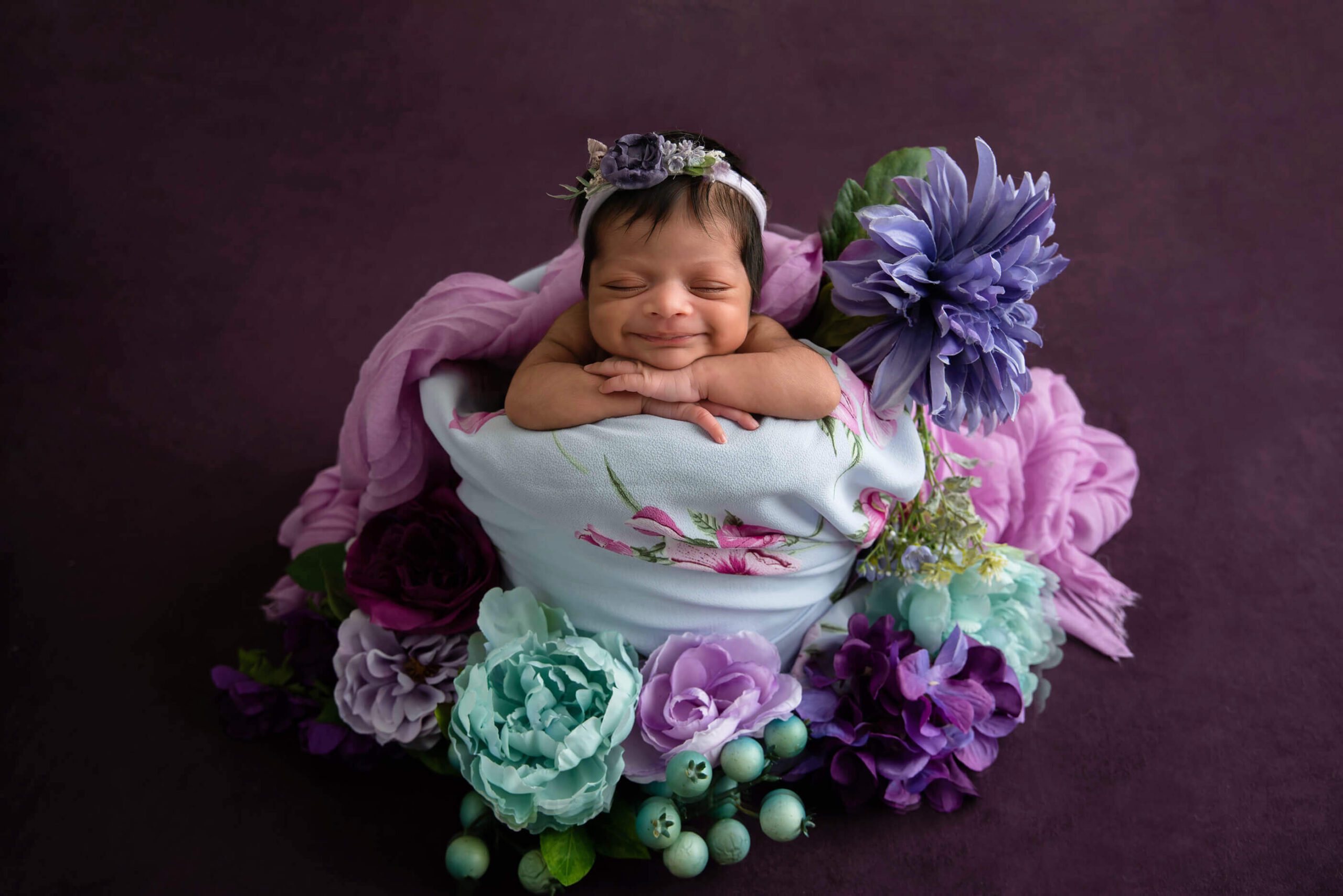 newborn girl with florals in purple colours Cambridge Newborn Photographer