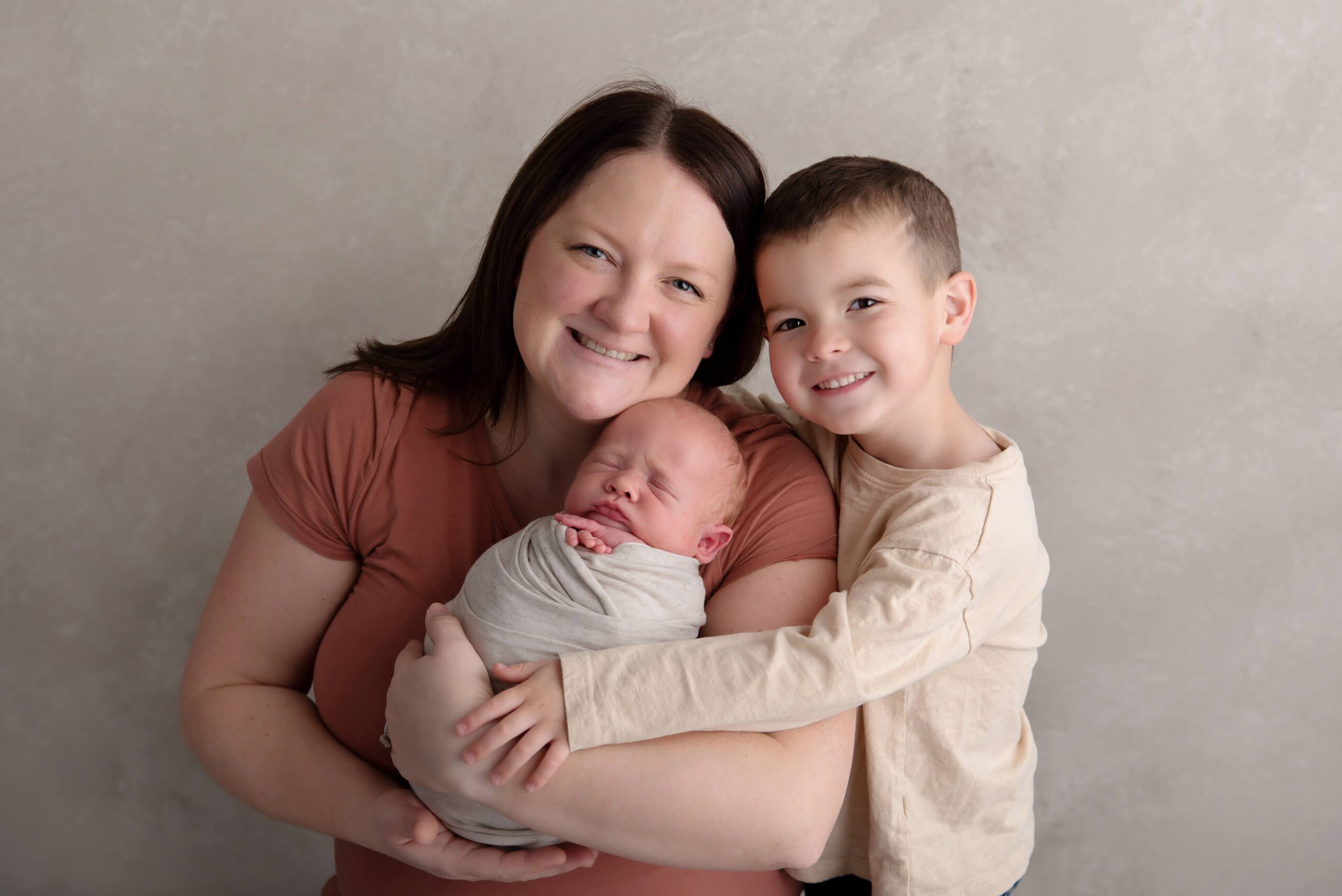mom with two boys for their newborn photography session