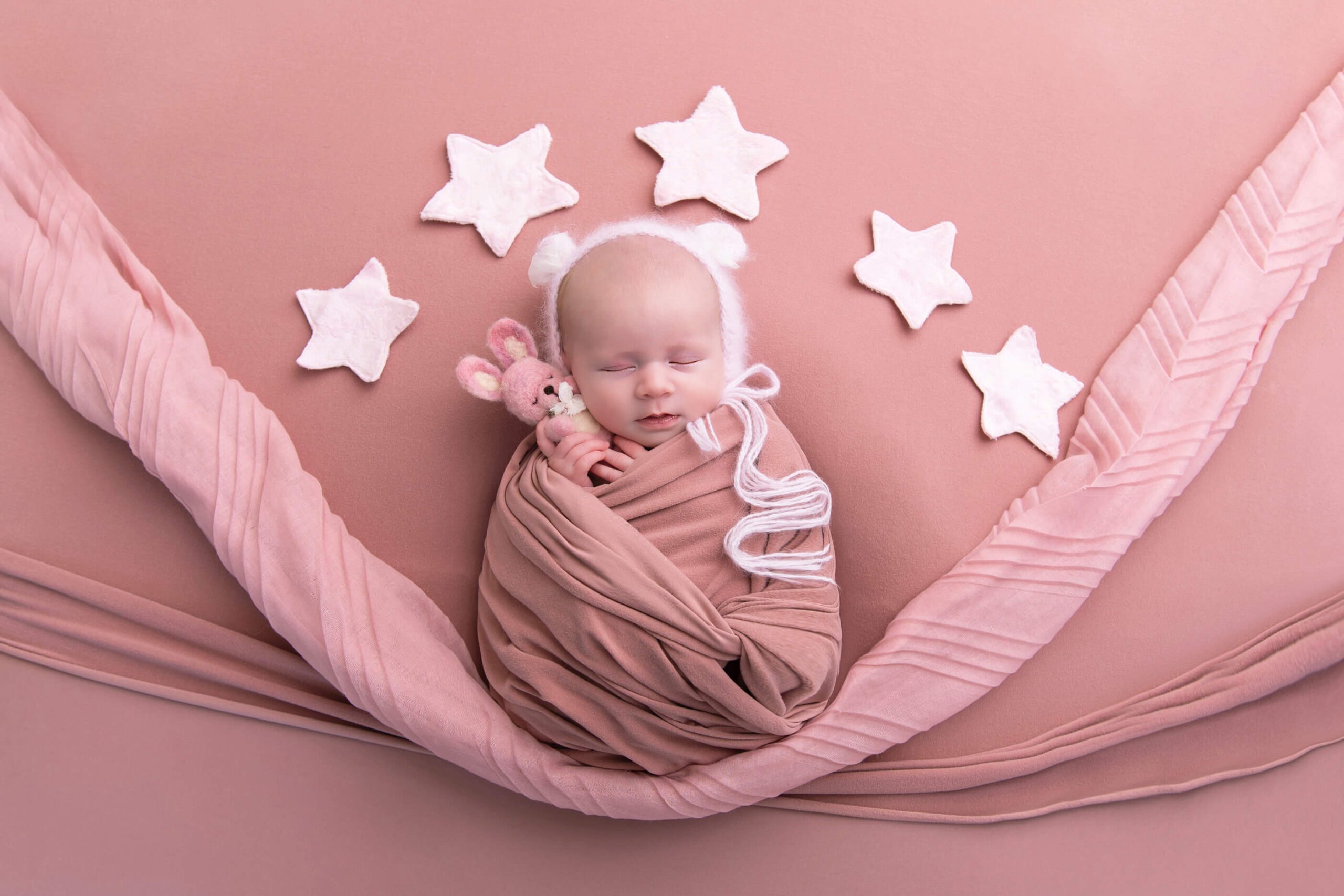 Cambridge newborn photos with girl with pink wrap and stars and bunny