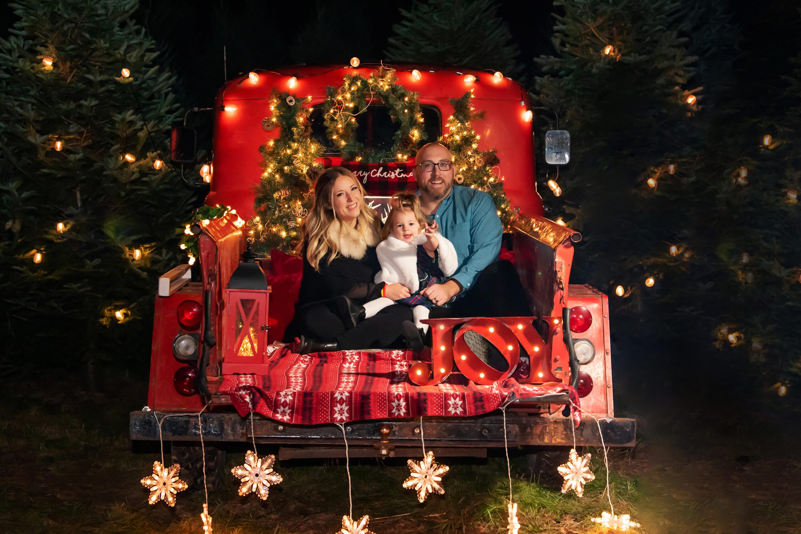 Family on a Red Truck at night for their Christmas Family Photos