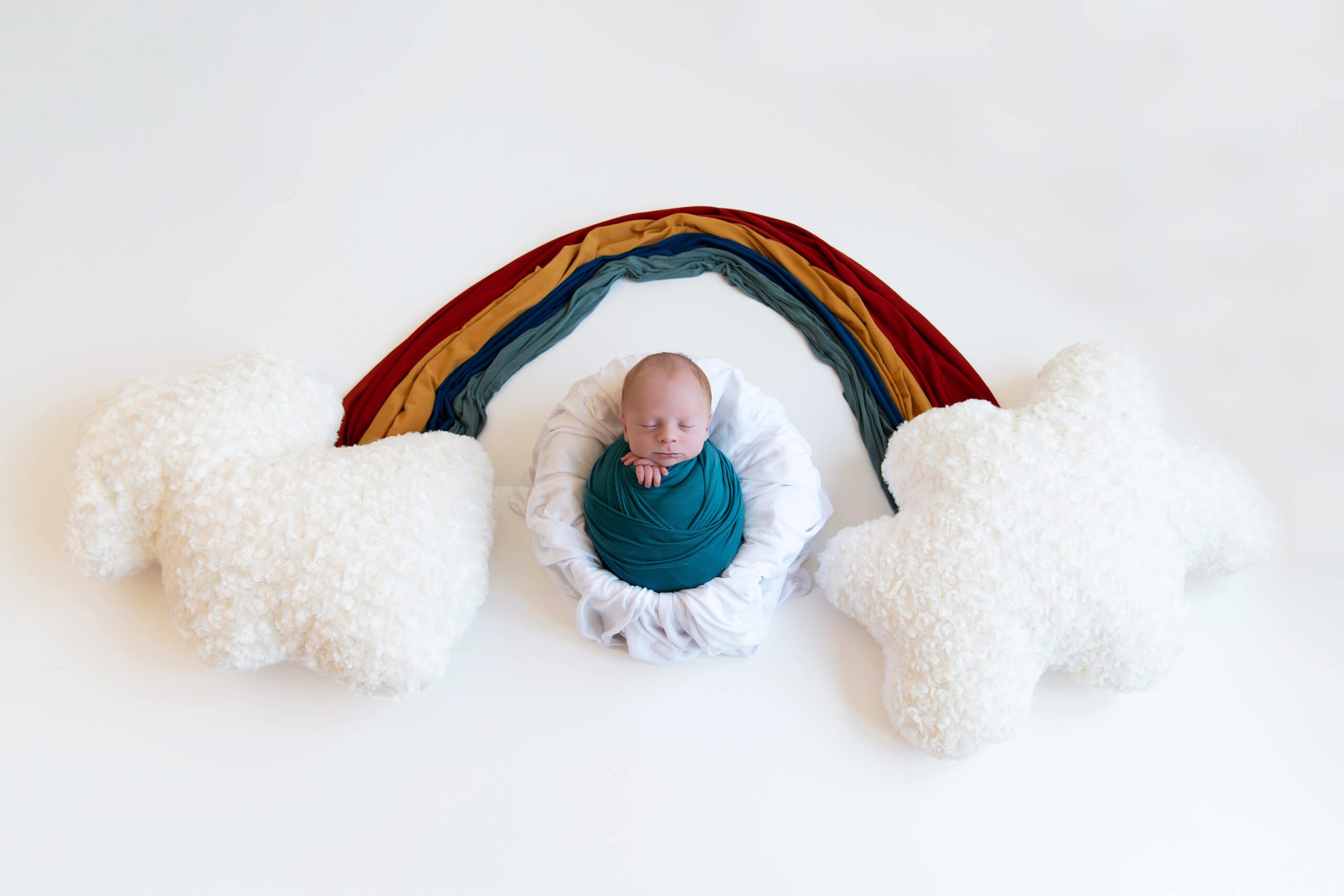 Rainbow Baby on white with a boho style rainbow, Burlington Ontario Newborn photographer