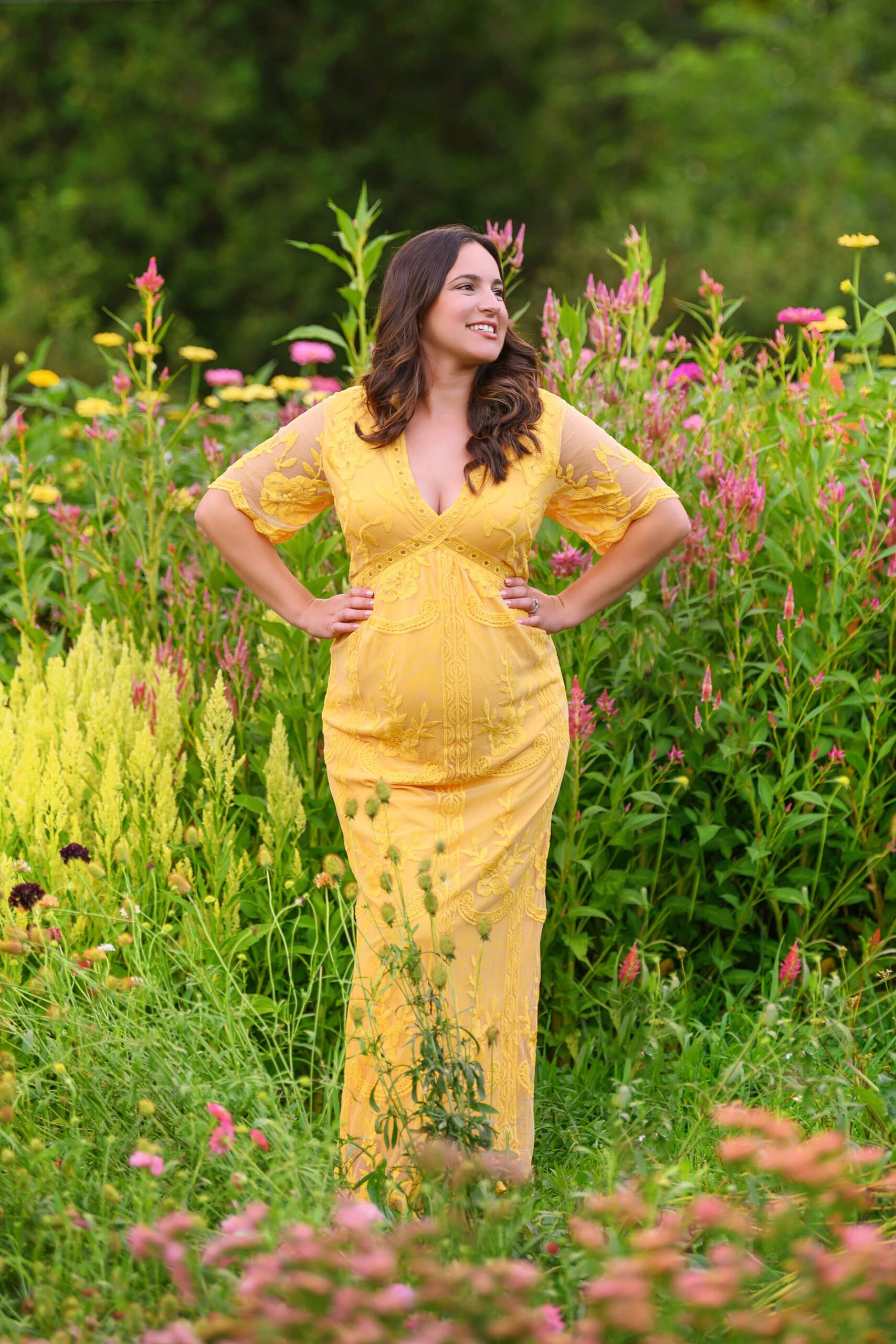 Mom to be in yellow dress in a flower garden for her Toronto Outdoor Maternity Photos