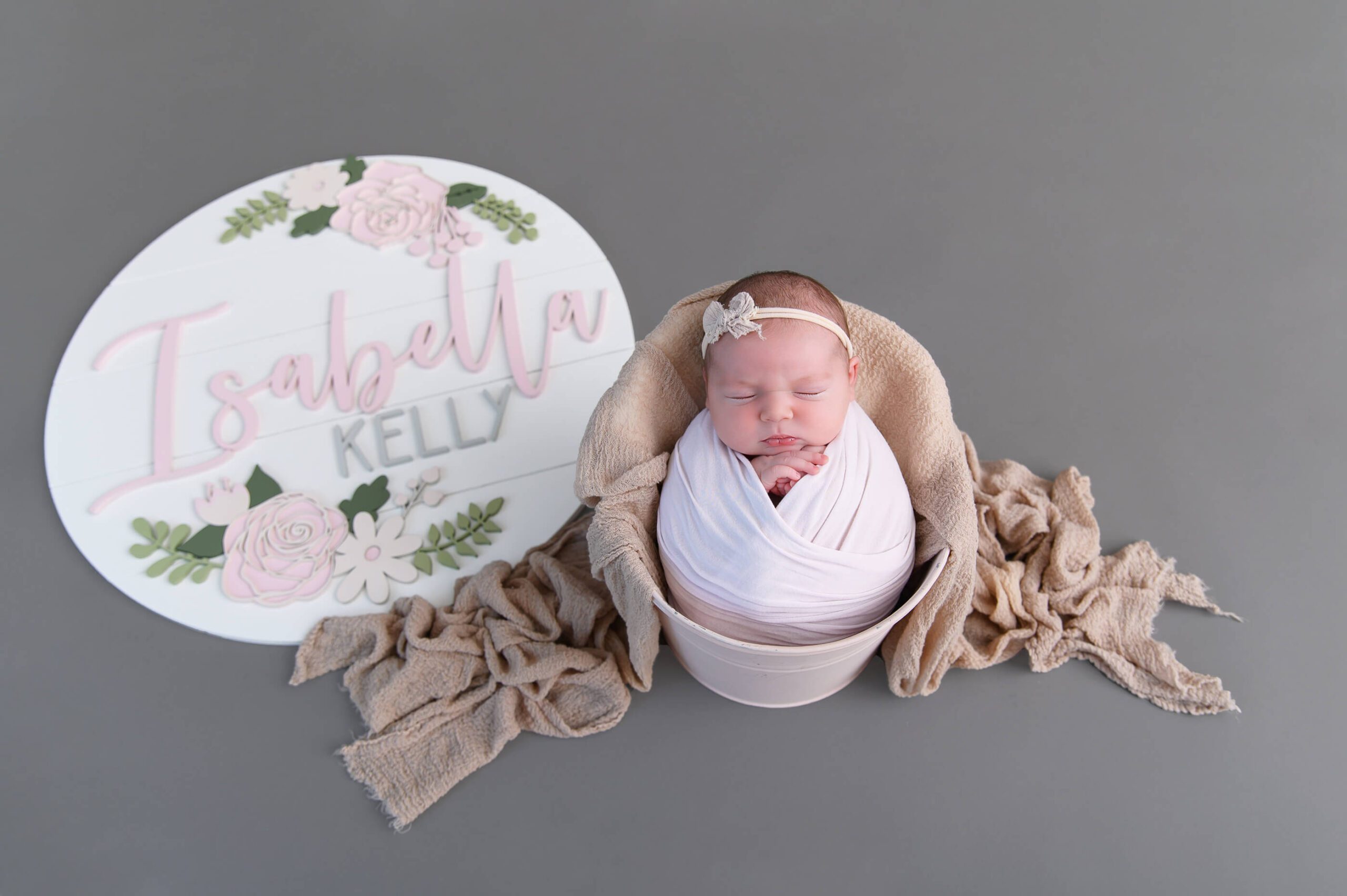 newborn girl wrapped in pink in a bucket with her name sign beside her, Hamilton Newborn Photographer