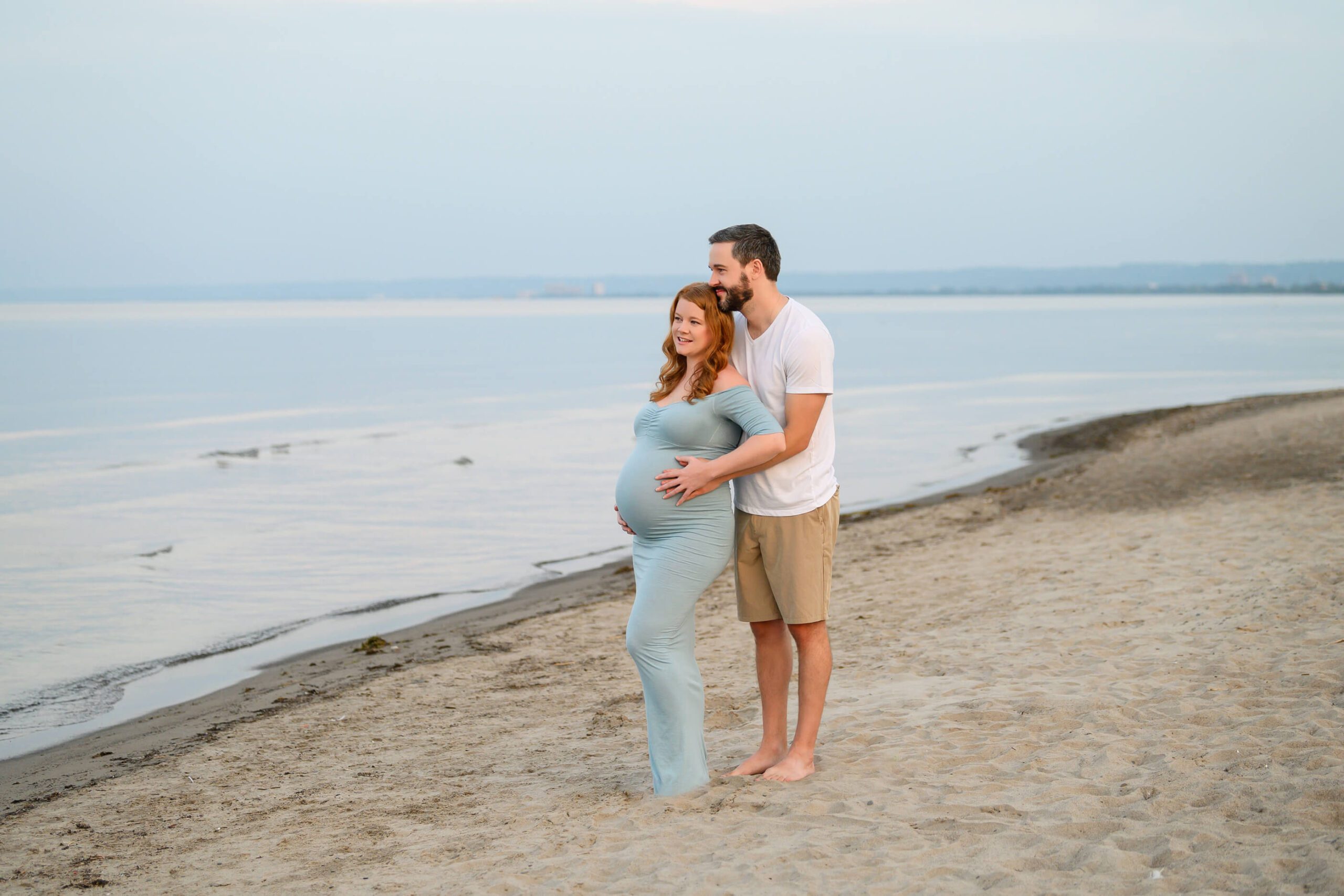 Husband and wife at the beach for their Toronto maternity photography session