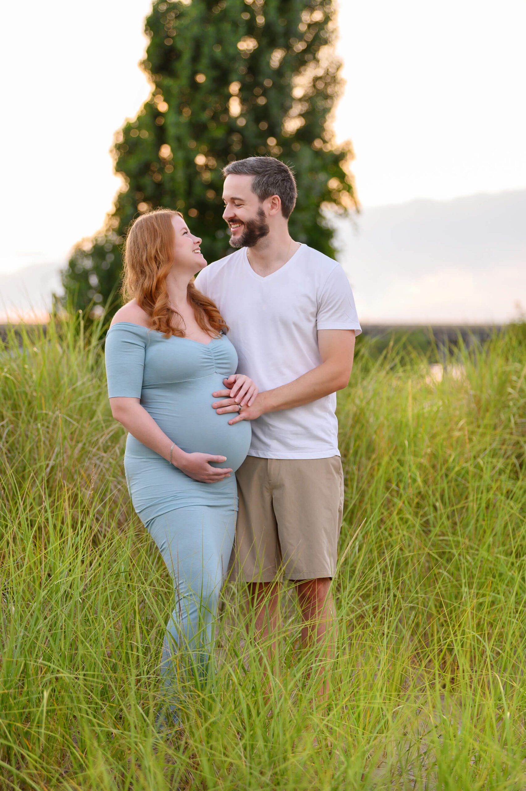 Husband and wife soon to be parents staring at each other with smiles Burlington Maternity Photography