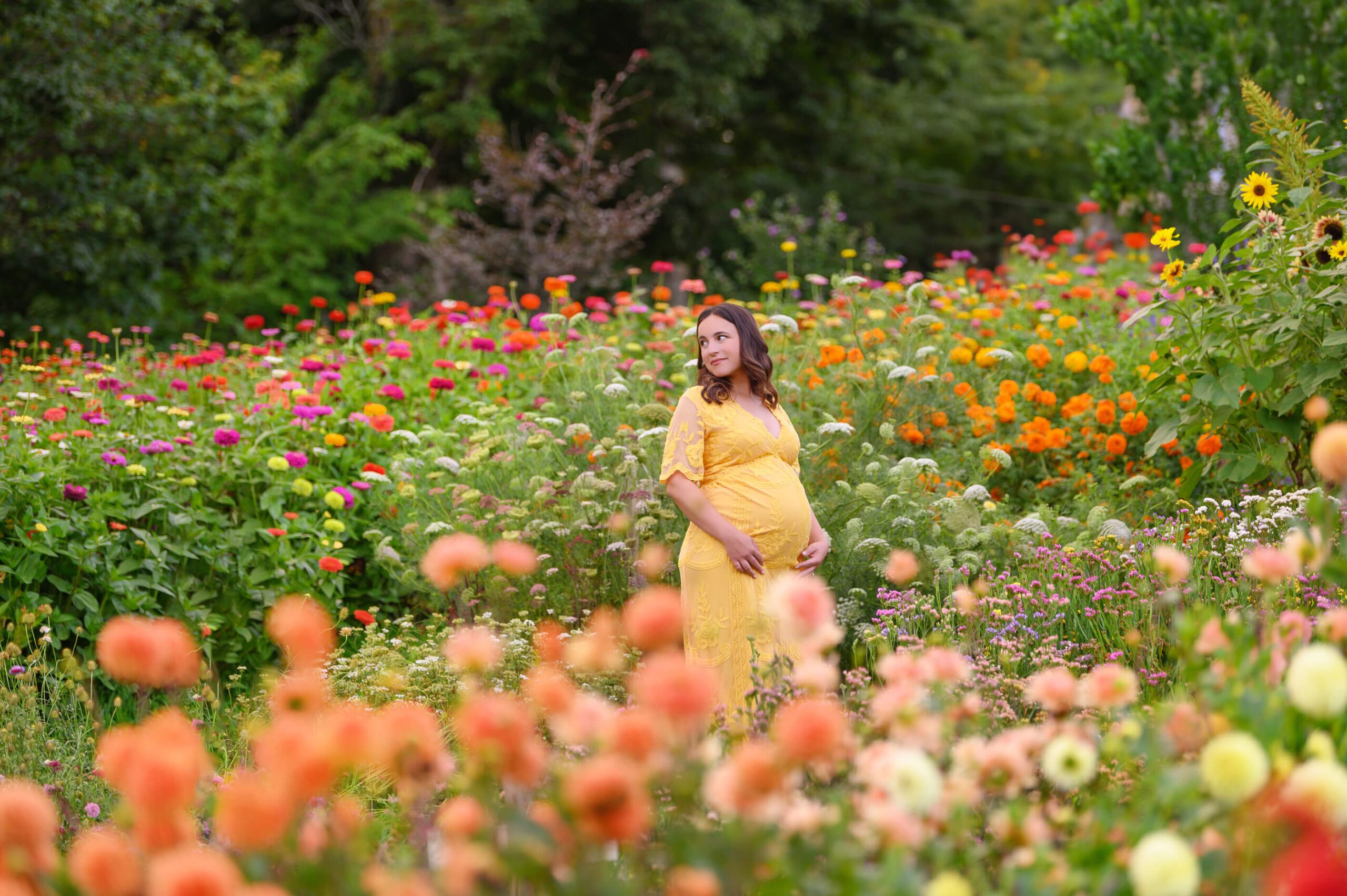 mom in yellow dress amongst the flowers Toronto Maternity Photographer