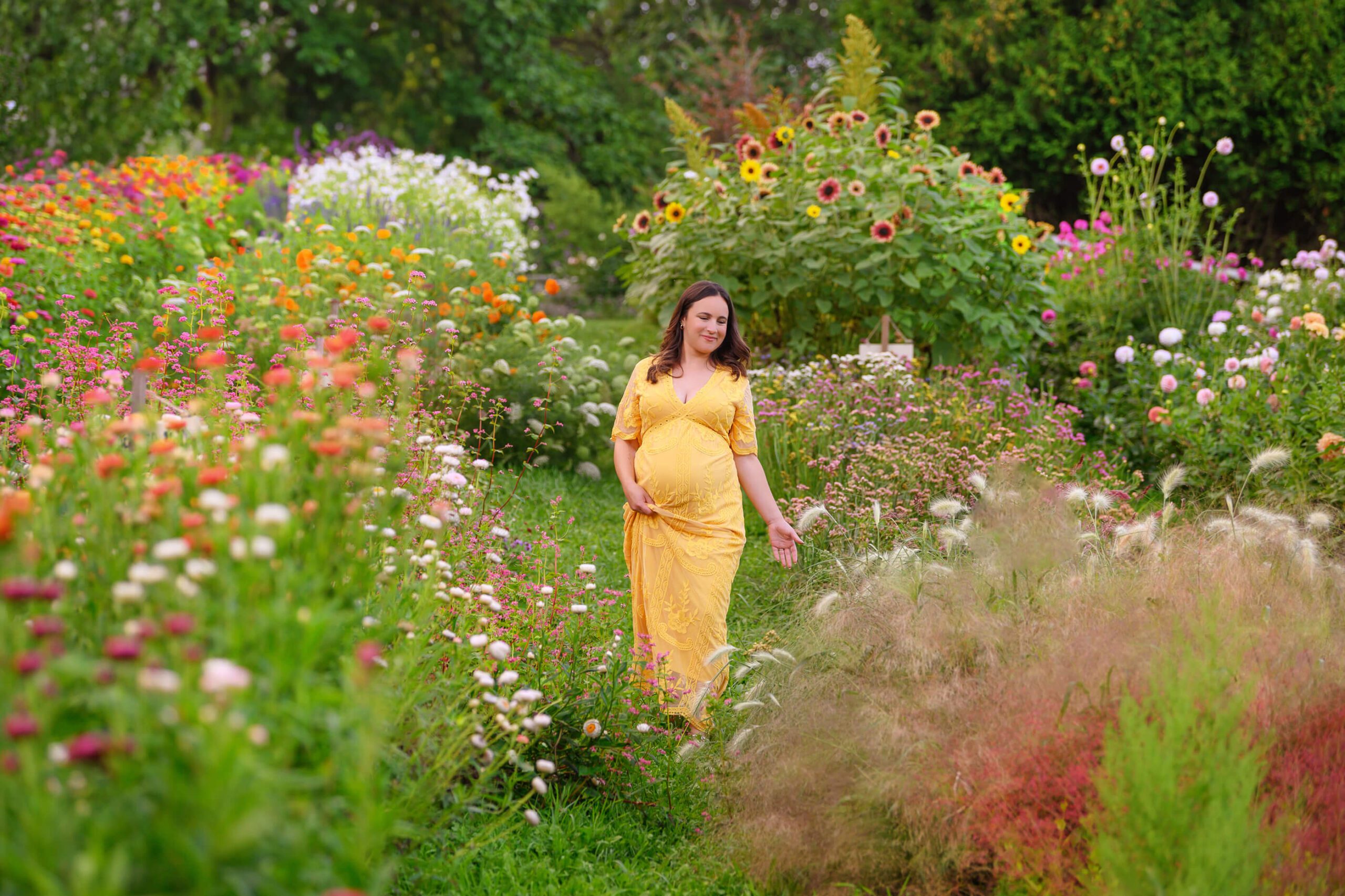 Burlington Maternity Photographer mom walking in yellow dress smiling