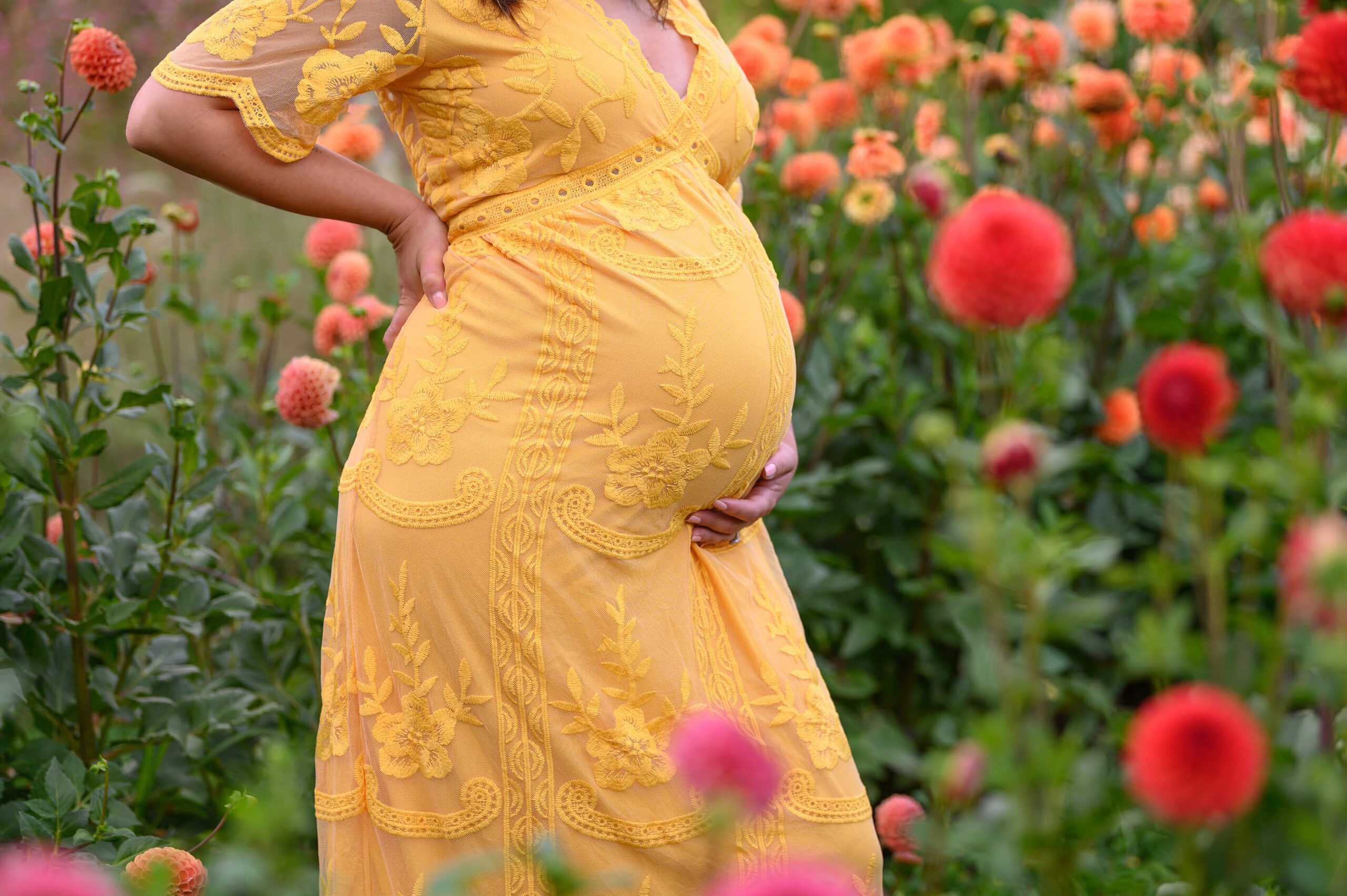 up close photo of maternity belly mom in yellow dress