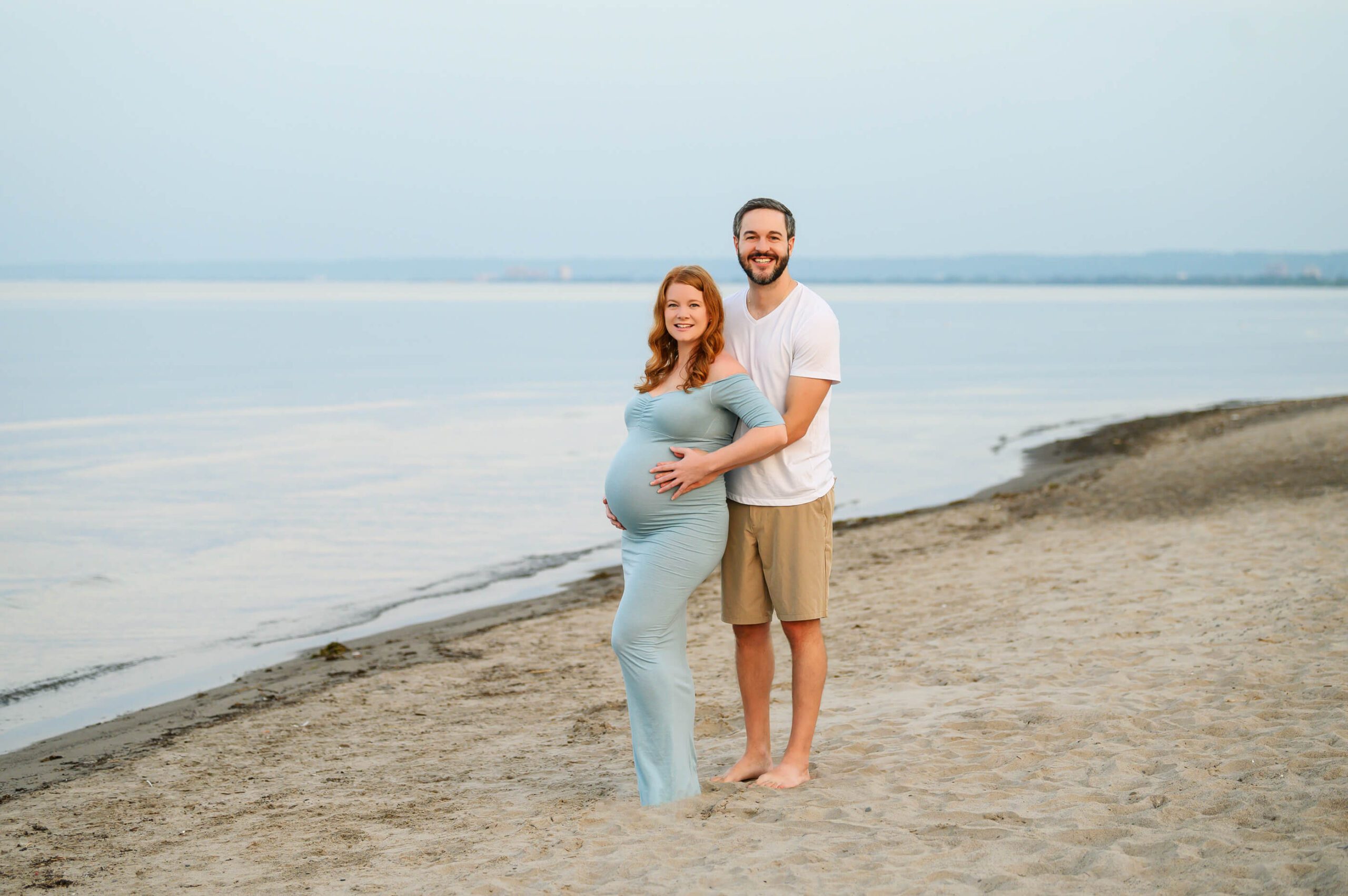 husand and wife for a beach maternity session at the golden hour