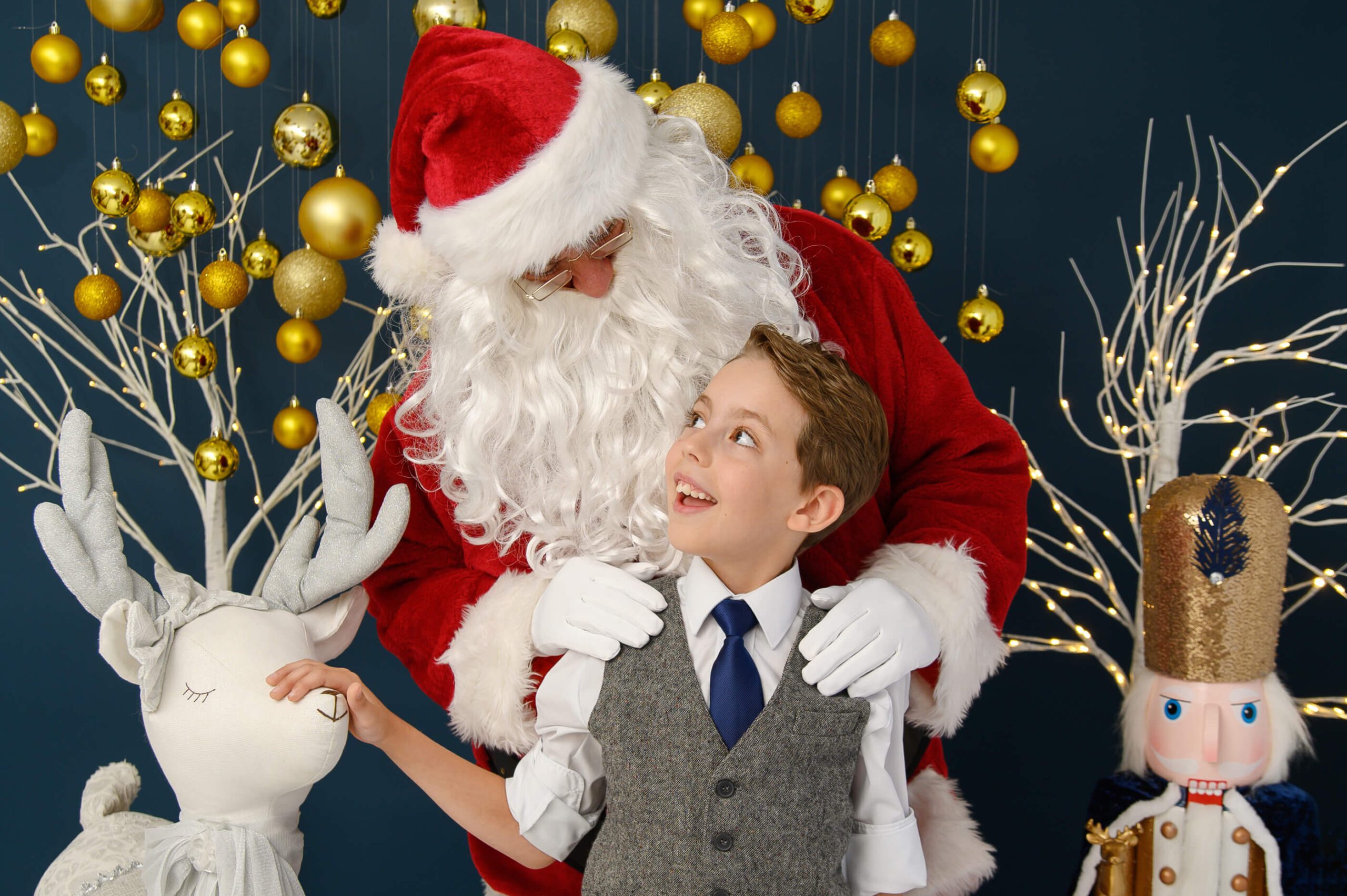 Young Boy looking up at Santa Photos Toronto smiling. 