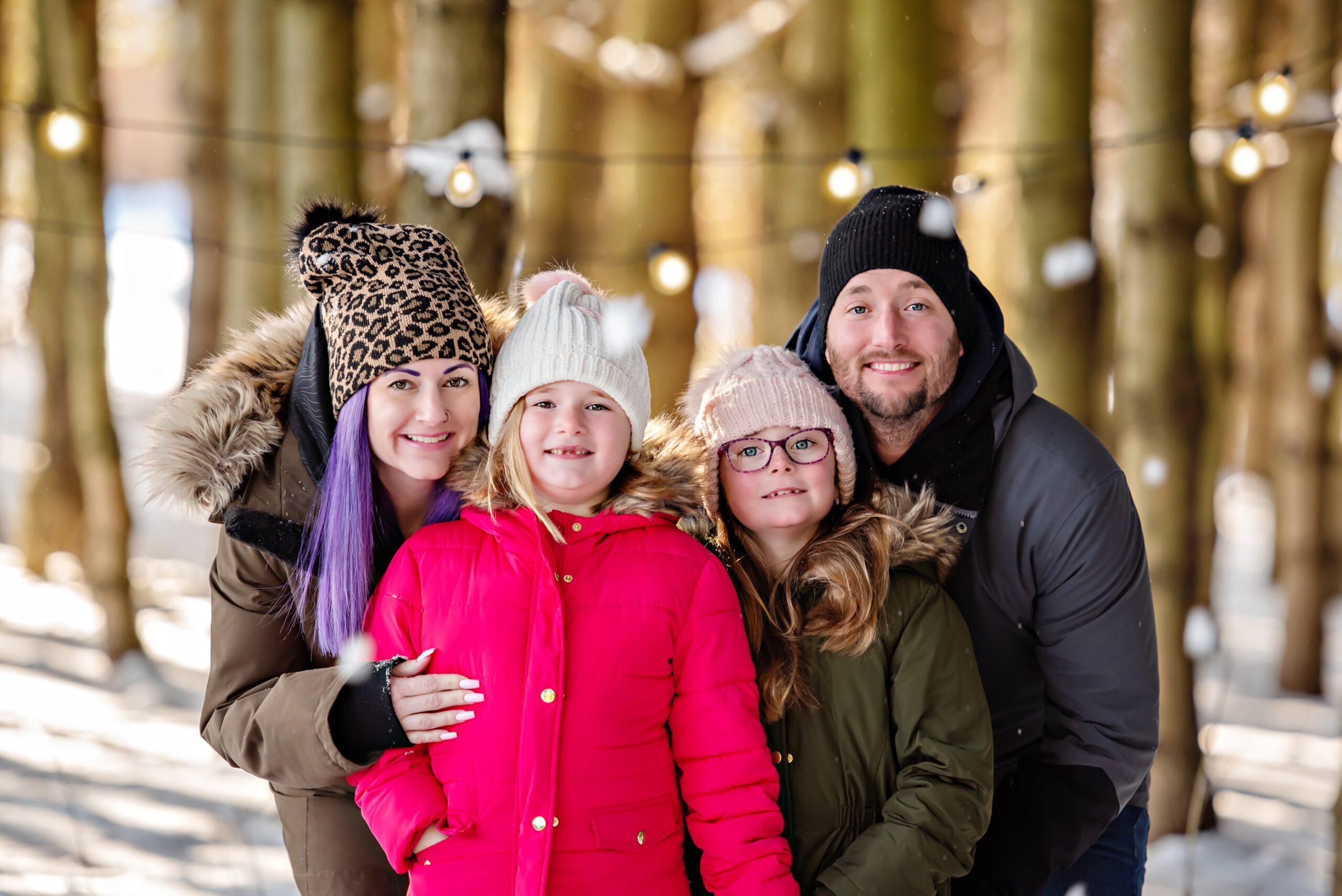 mom and dad with two daughters for the winter family photo session.