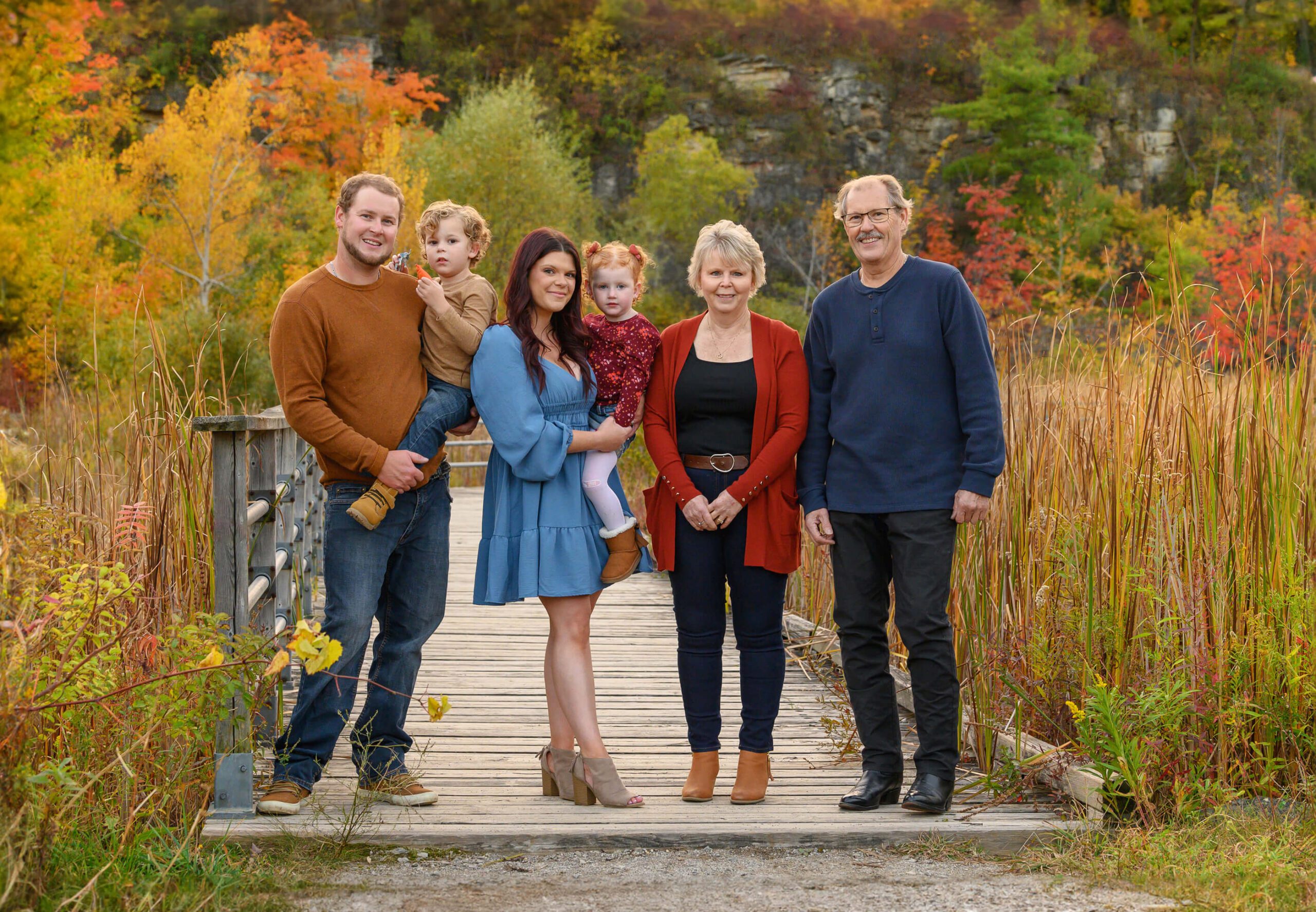Grandparents with son and daughter-in-law and two grandkids boy and girl, Burlington, Ontario fall extended family photos.