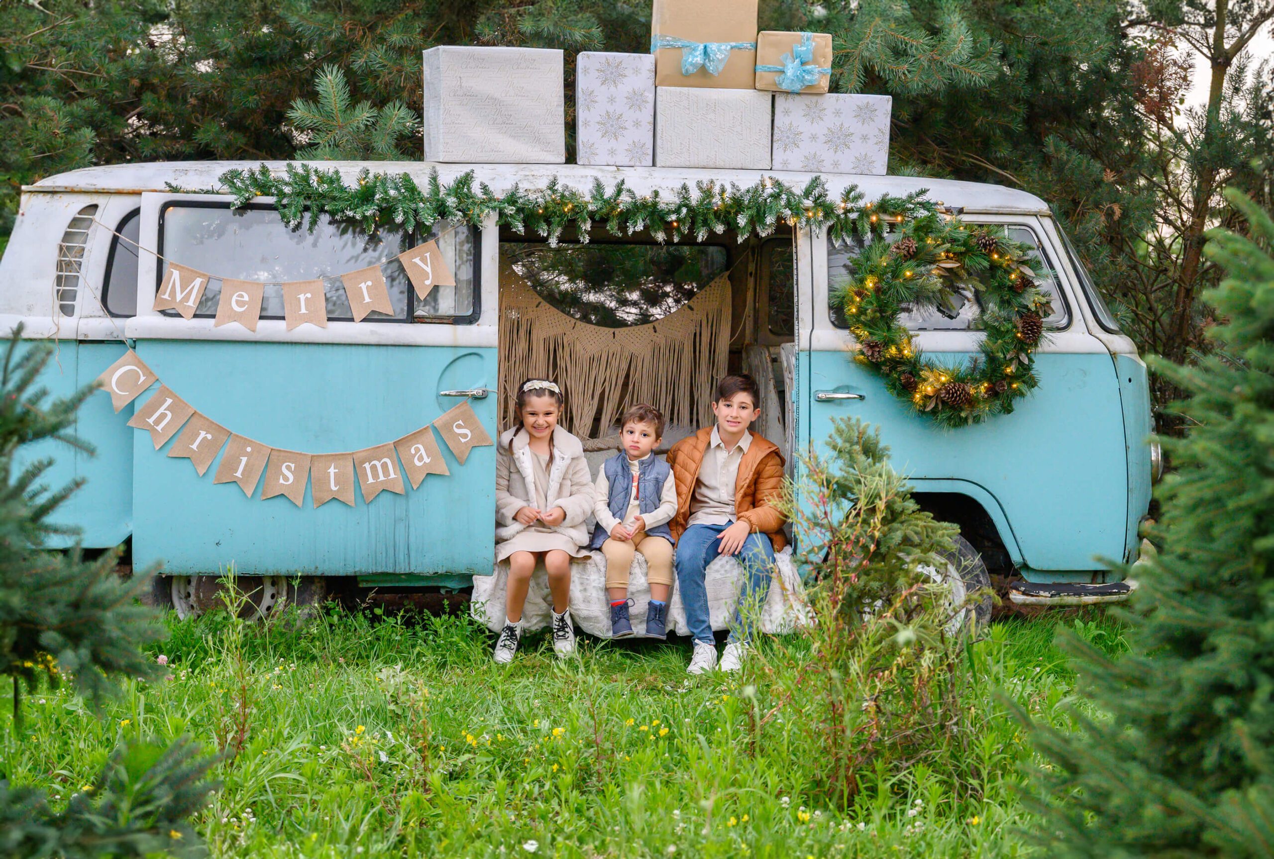 Three Kids sitting in a VW Bus for their Family Christmas Photos