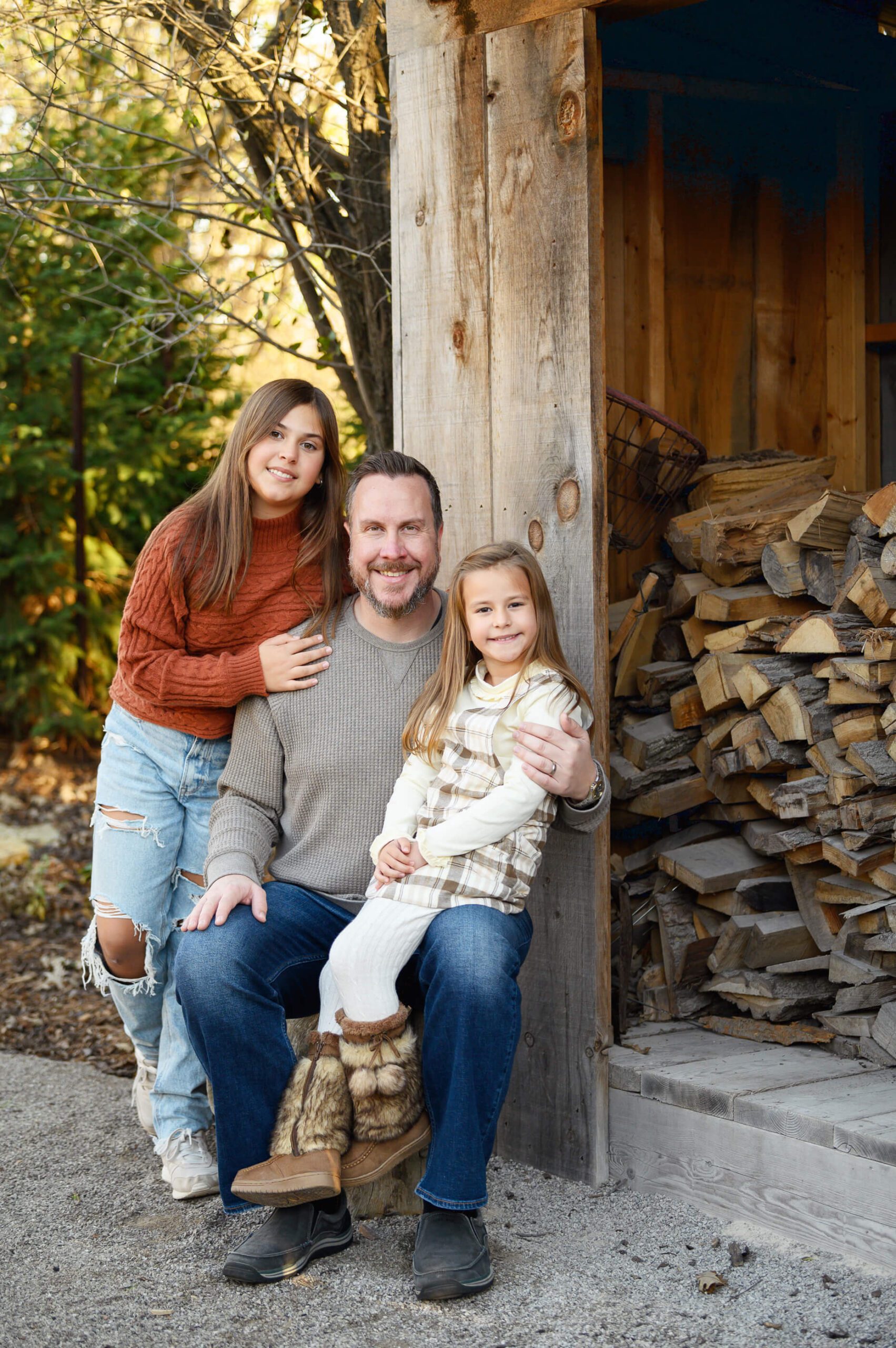 Dad with two daughters for their fall family photography session