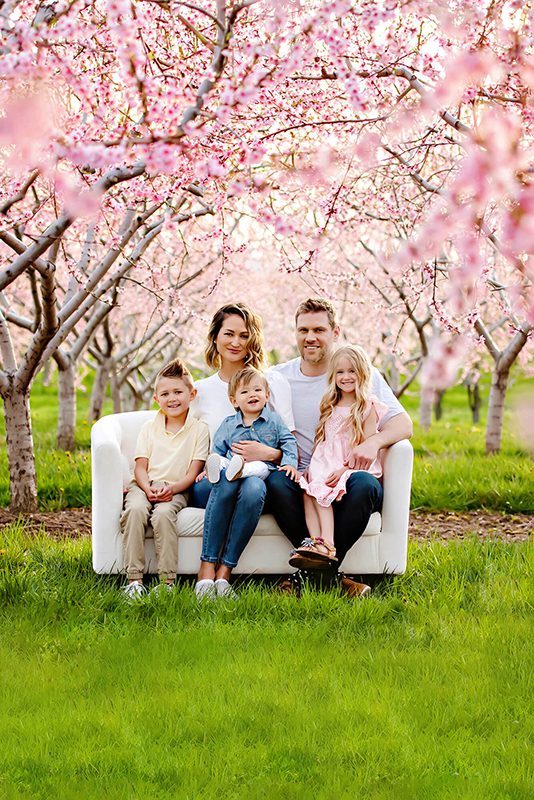 Burlington Family Photographer Cherry Blossom Family photos, family of 5 sitting on a couch amongst the cherry blossoms