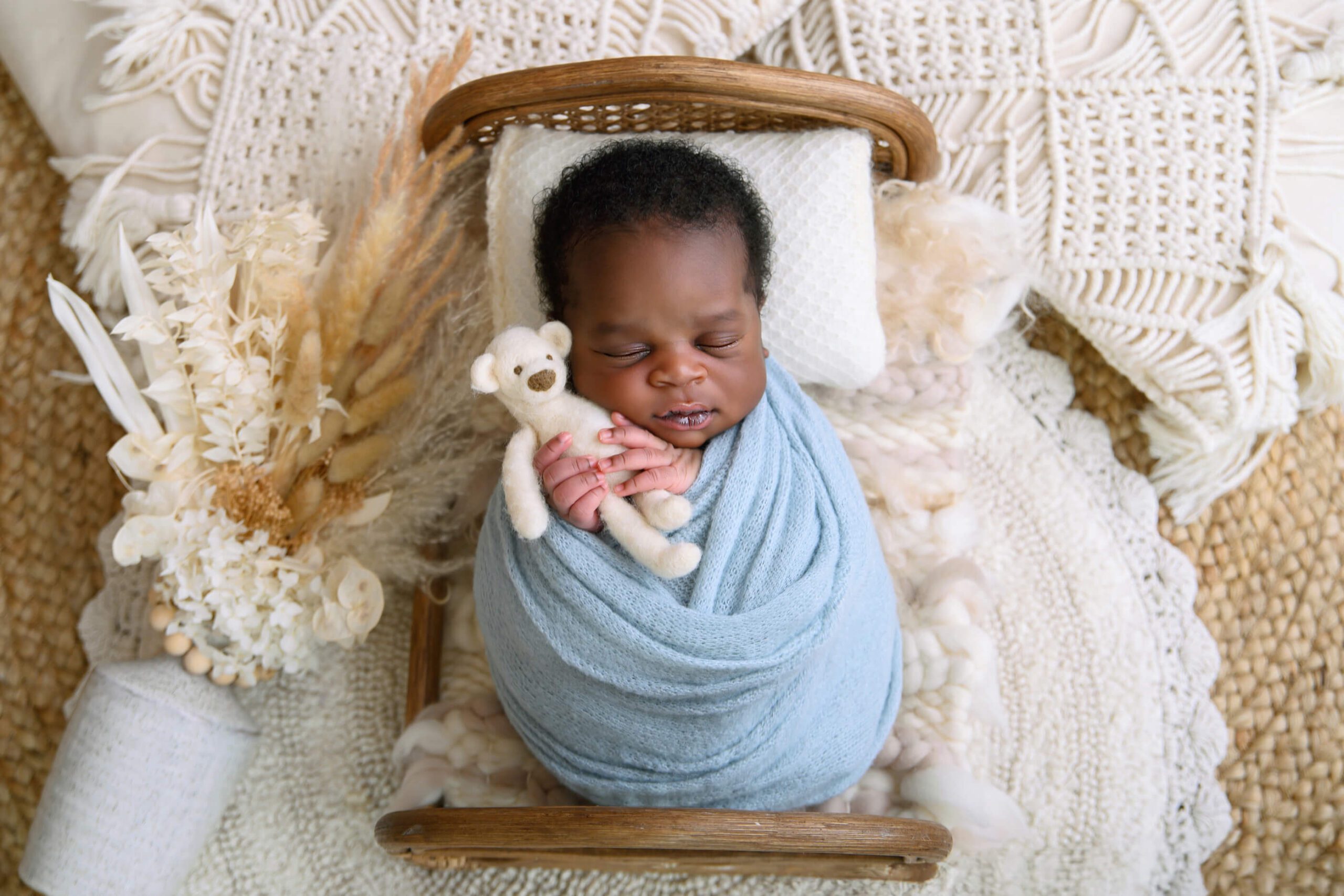 Boho newborn photography session baby boy wrapped in a blue wrap. Toronto Newborn Photographer